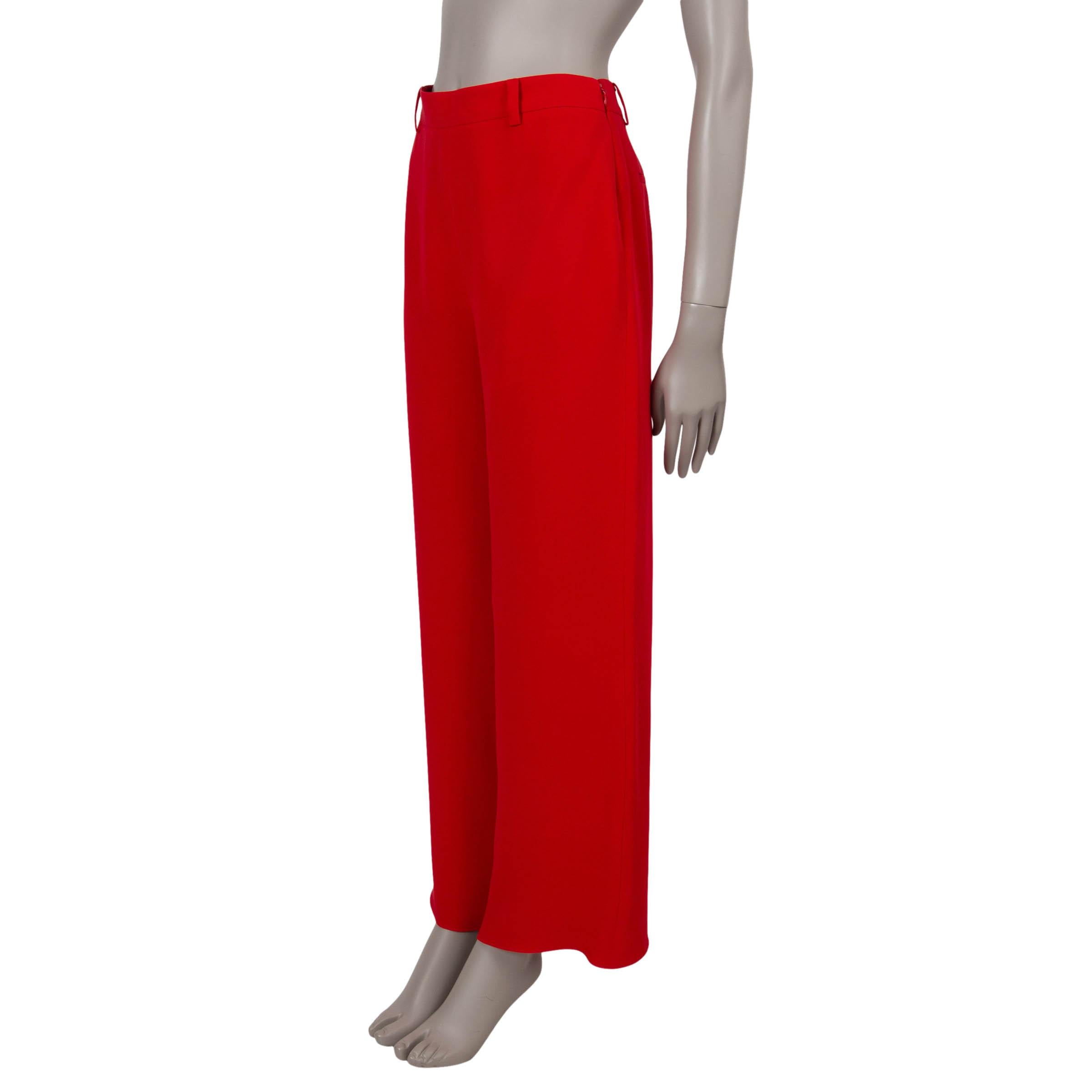 This 100% authentic Valentino dress pants in red grisaille wool (100%) exude timeless elegance. Featuring a high-waisted silhouette with wide legs and creased front and back, they offer a polished look. Designed with two slant pockets and two back