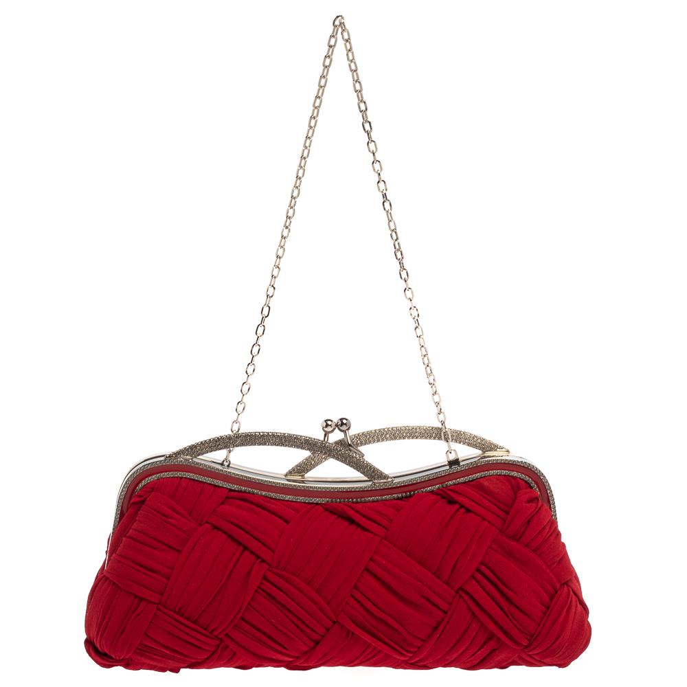 Valentino's feminine sensibilities are seen in its alluring silhouettes that are loved by women worldwide. This stunning clutch is an example of that! Interwoven from red fabric, it features crystal embellishments, a kiss-lock closure, and enough