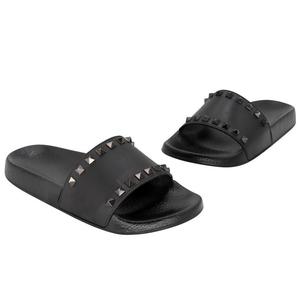 Here is another beautiful item by the world famous fashion house VALENTINO. The gleaming pyramid studs fashionable sandals dress up the vamp of a versatile slide sandal. These are perfect for daily use or simple a relaxing day in the pool!! These