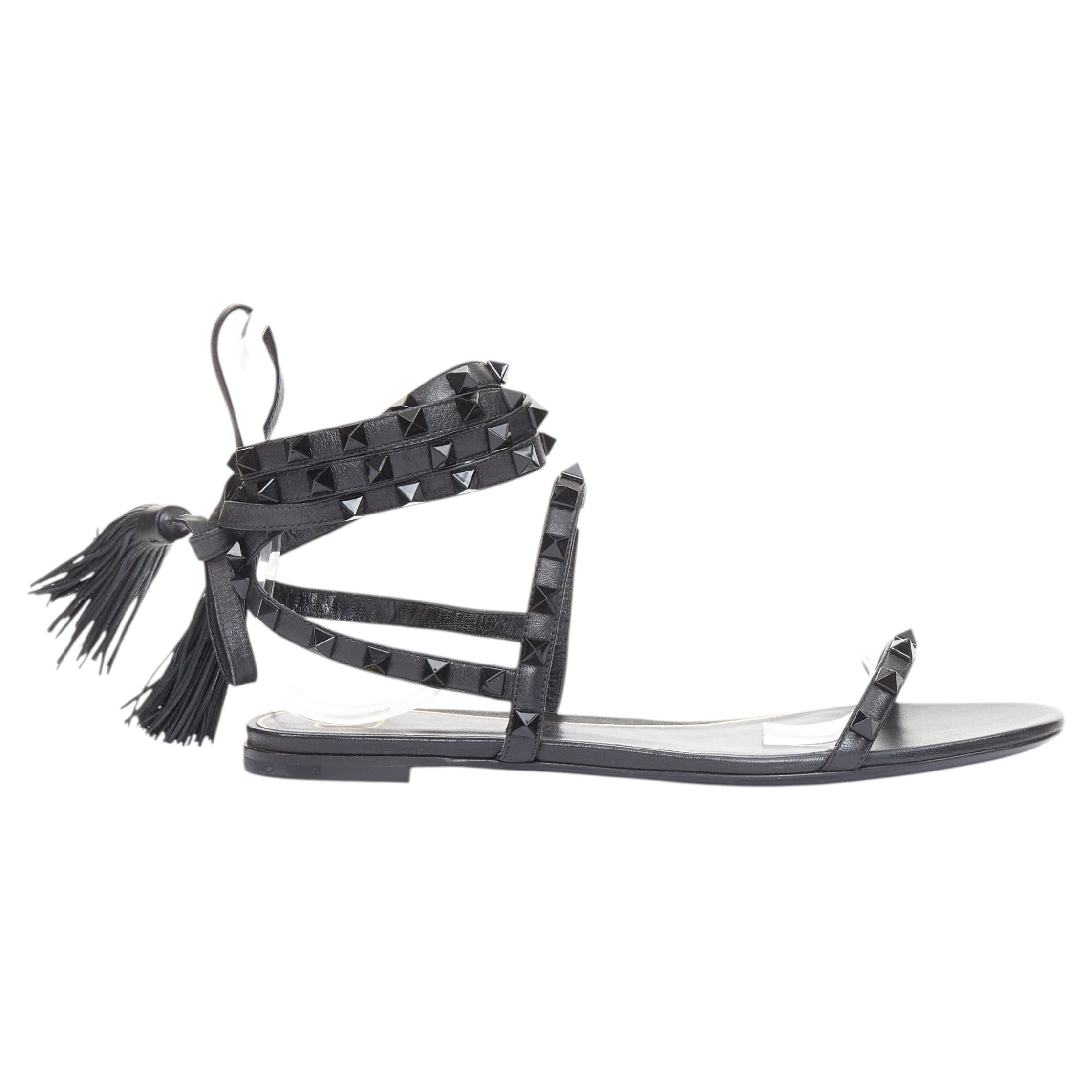 VALENTINO Rockstud black leather wraparound lace up tassel gladiator flats EU38 For Sale