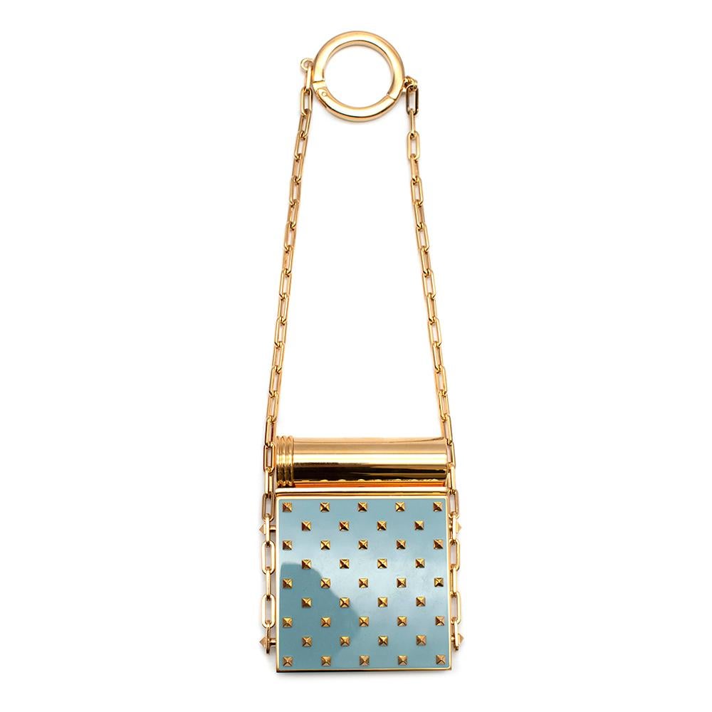 Valentino Rockstud Metal Compact Mirror and Lipstick Case
- Gold tone hardware with Teal face
- Opens up to a mirror
- Lipstick holder for replaceable lipsticks 
- Gold-tone chain with circular hook 
- Comes complete with presentation box

Materials