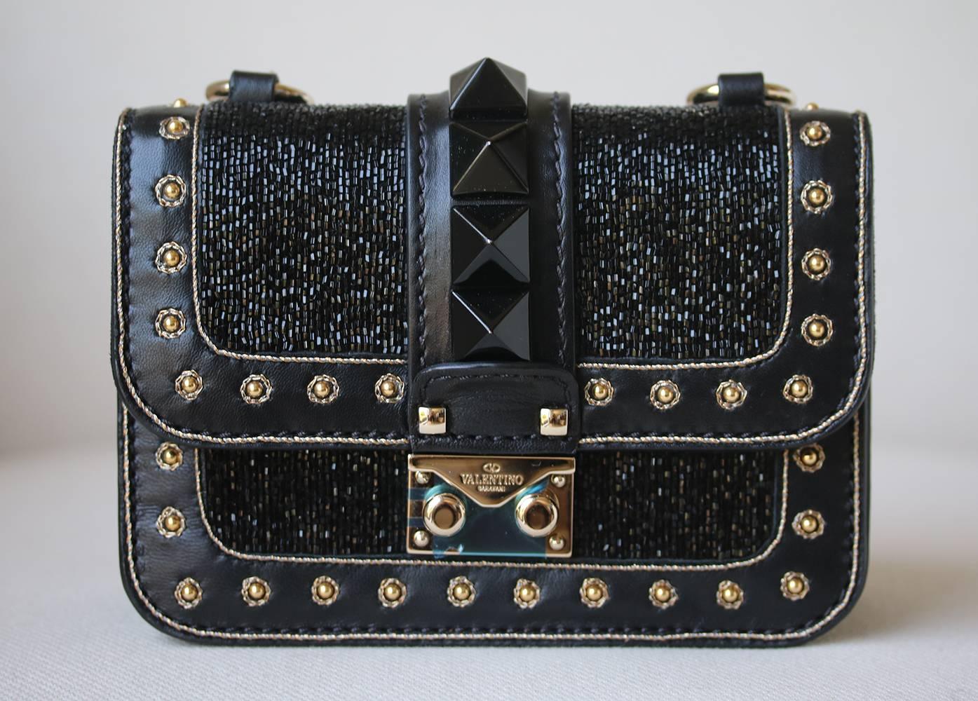 Valentino Mini Rockstud Bead Embellished Shoulder Bag. Black Leather Embellished With Beaded Body. Signature Pyramid Studs. Bordered With Gold Tone Studs. Gold Tone Hardware. Pushlock And Flap Closure. Back Slip Pocket. Suede Lined Interior.