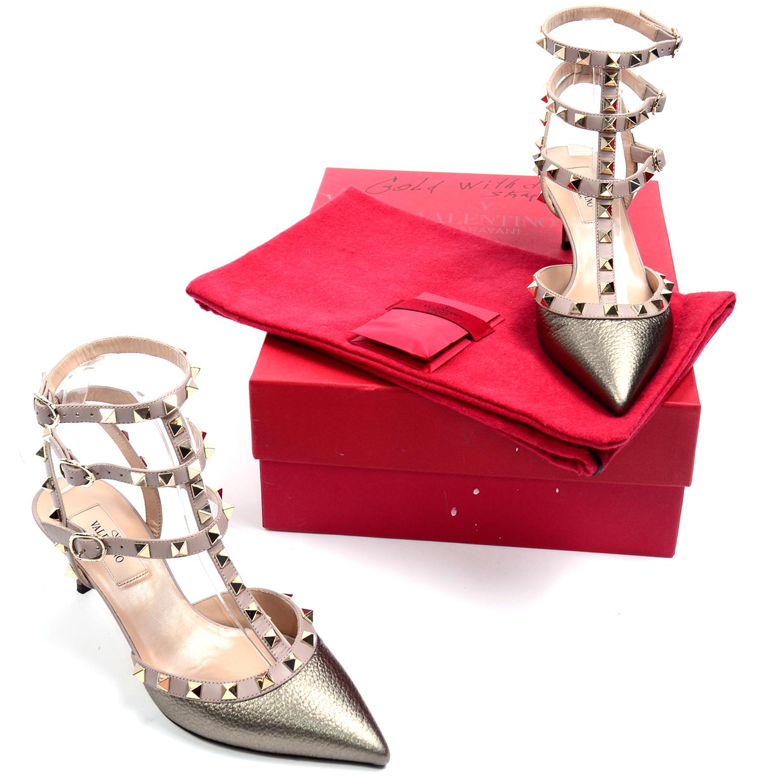 These Valentino Garavani Rockstud pumps are in a metallic dark gold leather and they feature 3 ankle strap side buckle fastenings, a pointed toe, a branded insole and a low stiletto heel. The gold-tone Rockstud embellishments are a Valentino