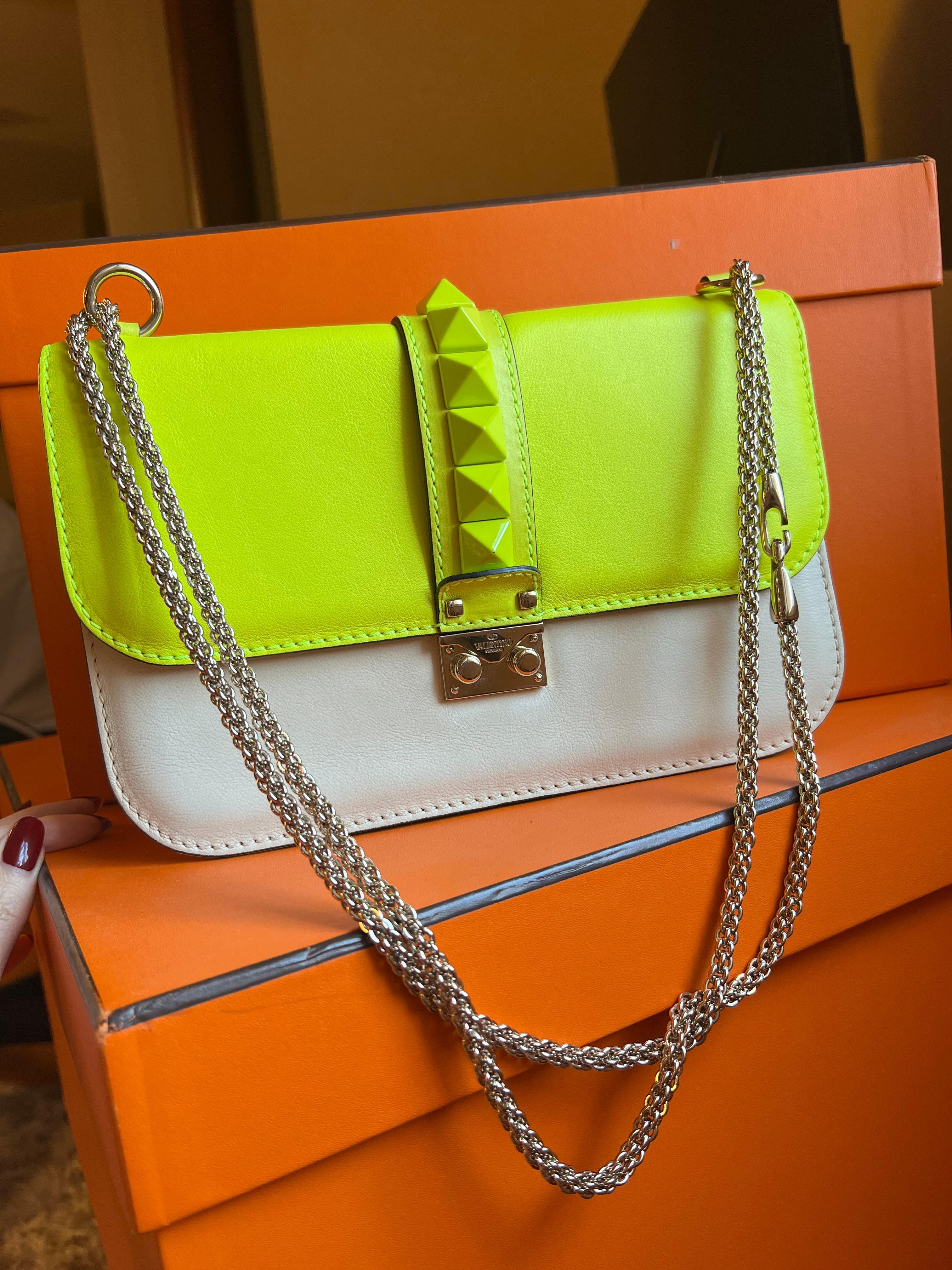 Valentino neon rockstud bag.
Great condition. Comes with dust bag.