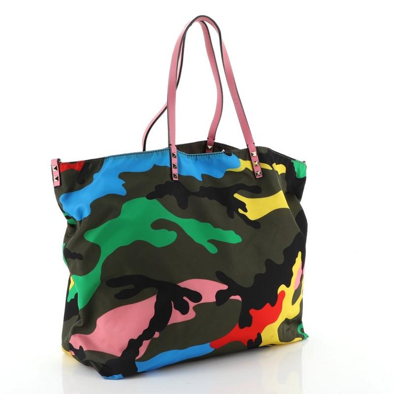 Valentino Rockstud Open Reversible Convertible Tote Camo Nylon Medium 

Estimated Retail Price: $1,695
Condition: Very good. Minor marks near base, splitting and cracking on handle and strap wax edges, scratches on hardware.
Accessories: With