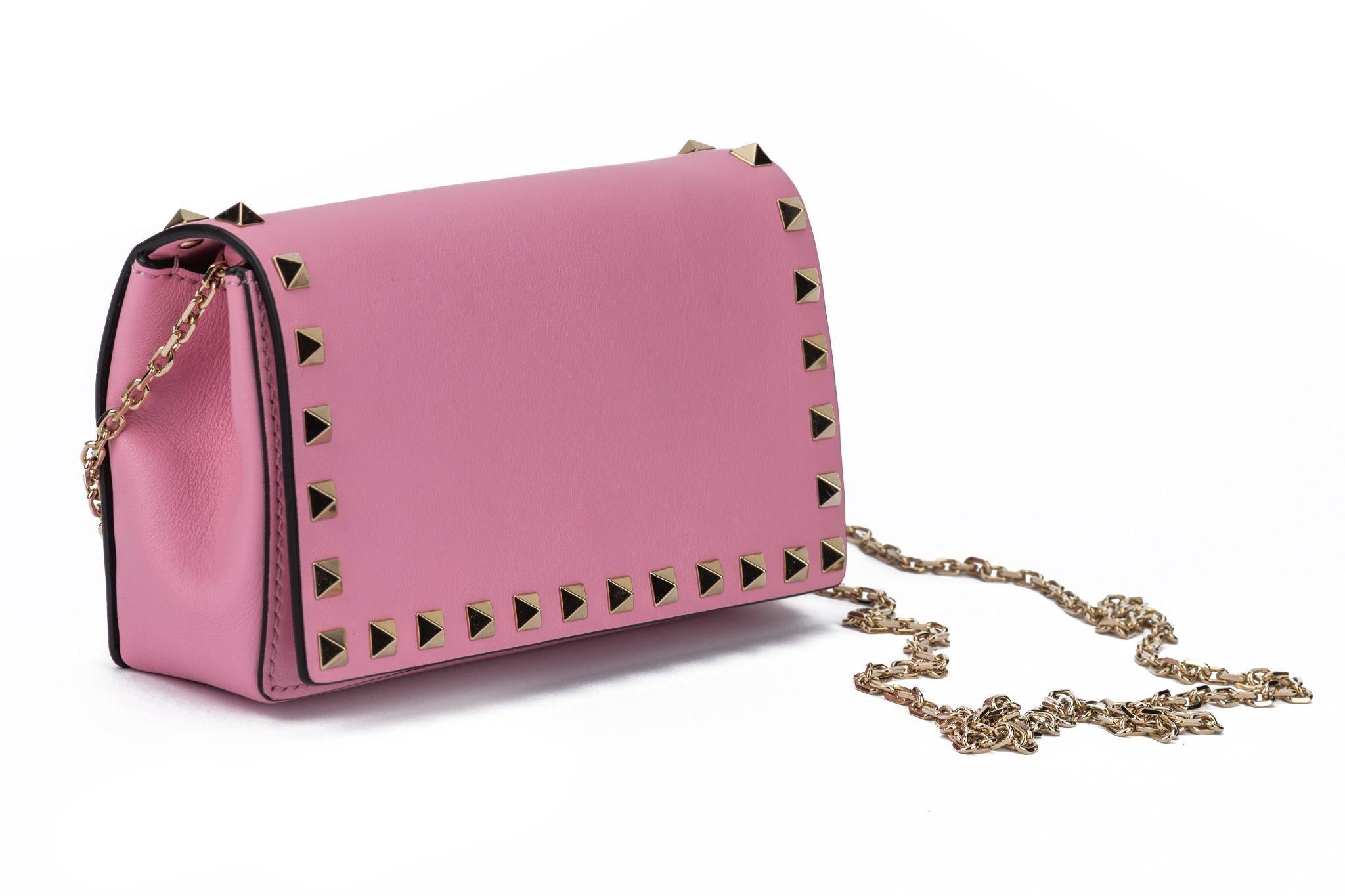Valentino Chain Leather Crossbody Bag in pink lambskin leather with silver studs at the edges around the whole purse. The bag is new and comes with plastic on hardware and generic dustcover.
