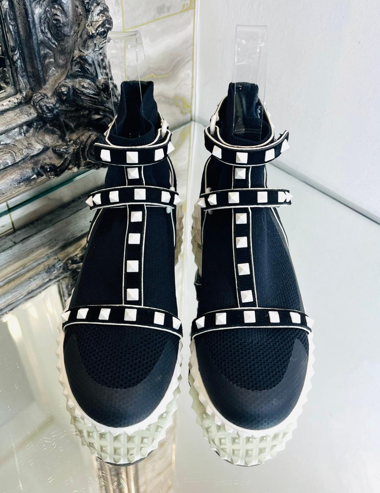 Valentino Rockstud Sock Sneakers

Black high-top sneakers designed with signature white pyramid stud detailing and bonded trim throughout.

Featuring Velcro ankle strap at rib knit collar, round toe and white, studded rubber soles.

Size –