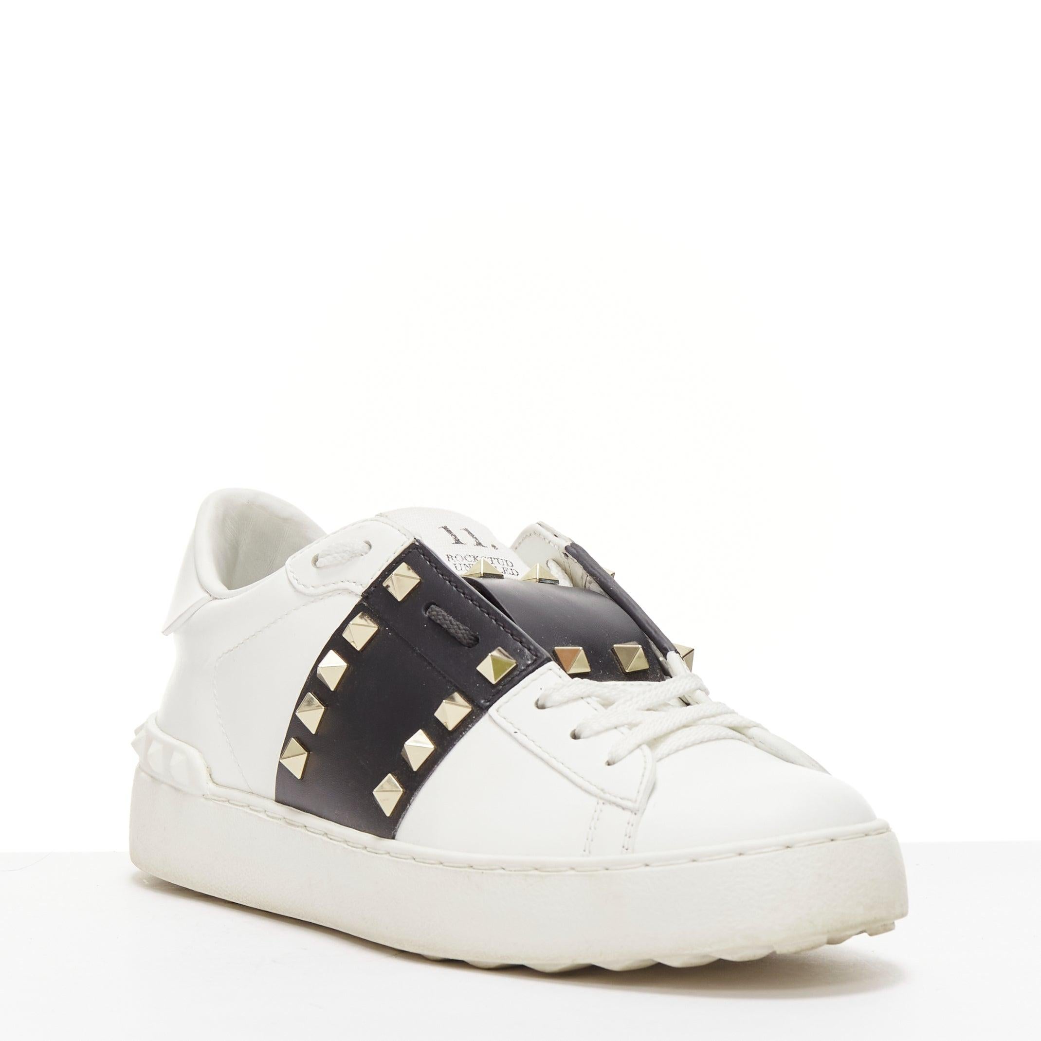 VALENTINO Rockstud Untitled Open black white leather studded sneakers EU37
Reference: NILI/A00066
Brand: Valentino
Model: Rockstud
Material: Leather
Color: White, Black
Pattern: Studded
Closure: Slip On
Lining: White Leather
Extra Details: White