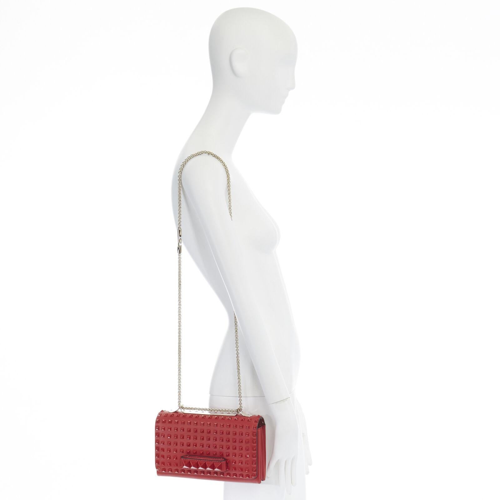 VALENTINO Rockstud Va Va Voom red leather tonal stud embellished flap clutch bag Reference: LNKO/A00790 
Brand: Valentino 
Model: Va Va Voom 
Material: Leather 
Color: Red 
Pattern: Solid 
Closure: Magnetic 
Extra Detail: Rockstud collection. Va Va