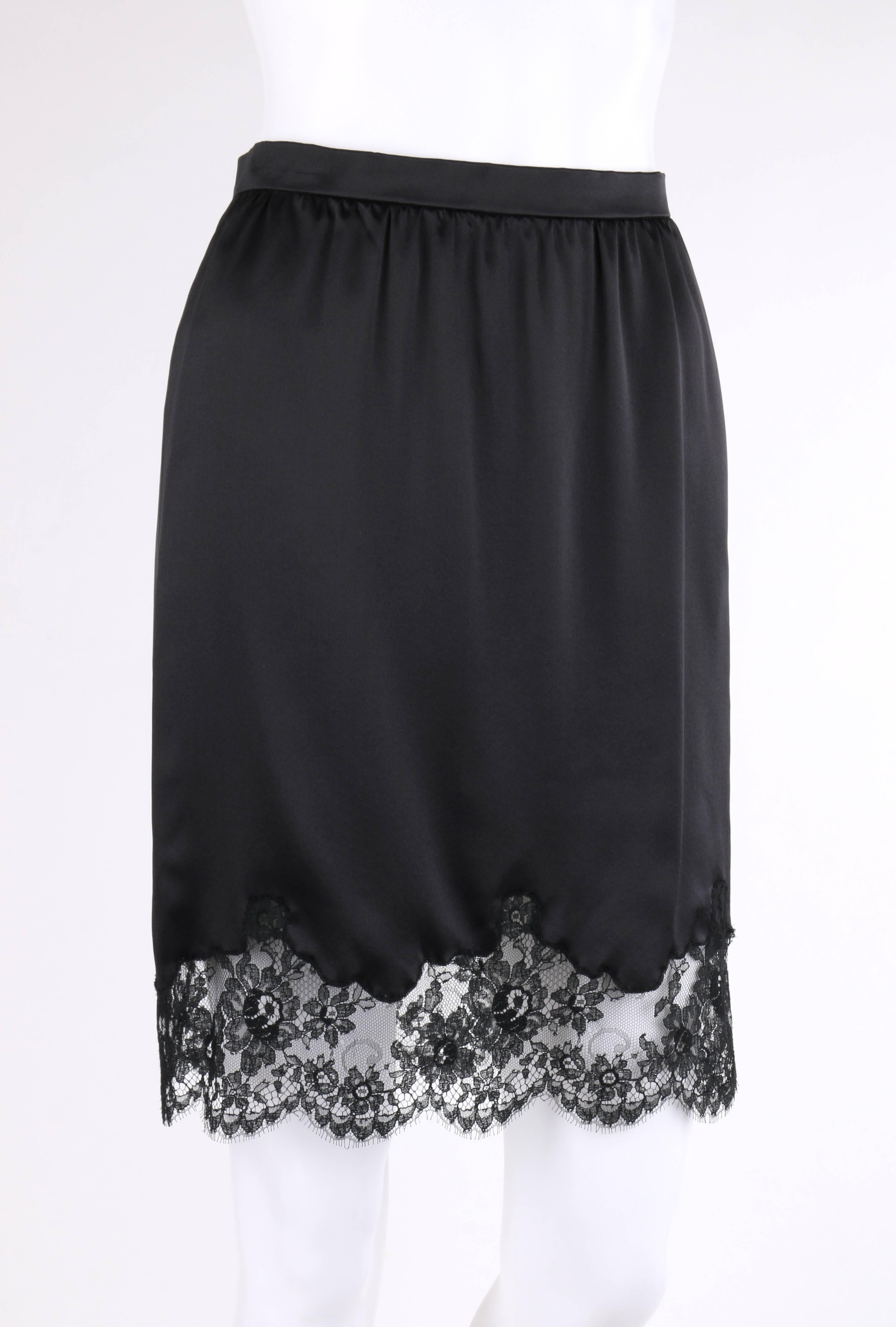 Valentino Roma black silk floral lace hem classic slip skirt. Thin banded waist. Left side seam invisible zipper closure. Gathered waistline. Black floral lace detail at hem with scalloped edge. Unlined. Marked Fabric Content: 