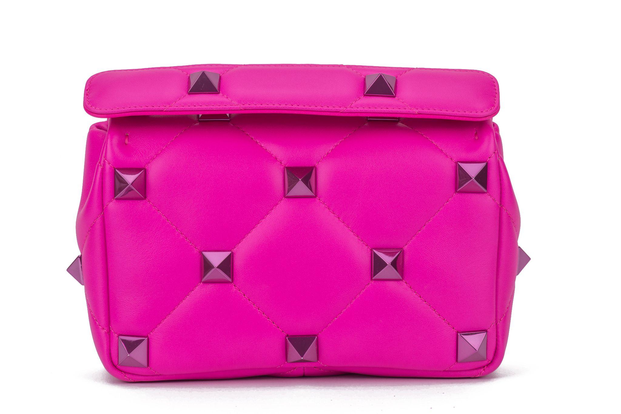 Valentino Roman Stud Collection in pink lambskin leather. Diamond-quilted shoulder bag with tonal studs and a versatile top handle and cross body strap combination. Handle drop 3.5”, detachable strap 25”.  The bag is new and comes with the original