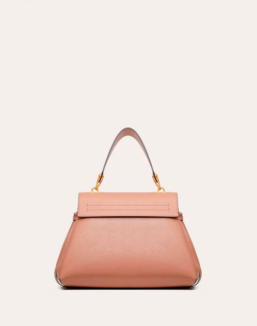 Valentino is one name that we can always count on for the latest in trends and the most versatile styles that stand the test of time. This top handle bag is one such creation featuring a gorgeous body accented with a front flap that carries the
