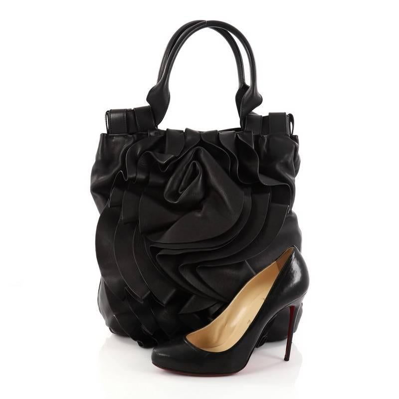 This authentic Valentino Rose Vertigo Tote Leather is a fun and eye-catching piece that can glam up your everyday wardrobe. Crafted in luxurious black leather, this feminine tote features layers of black leather to create a cascading rosette,