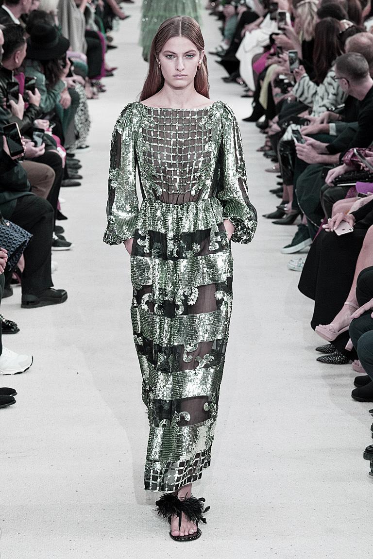 A stunning 70's inspired Valentino Demi Couture evening gown that sparkles and shimmers on the runway. Hand sewn sequins strategically placed for great color and visual appeal.     Features a bateau neckline,  slender bishop sleeves, and concealed