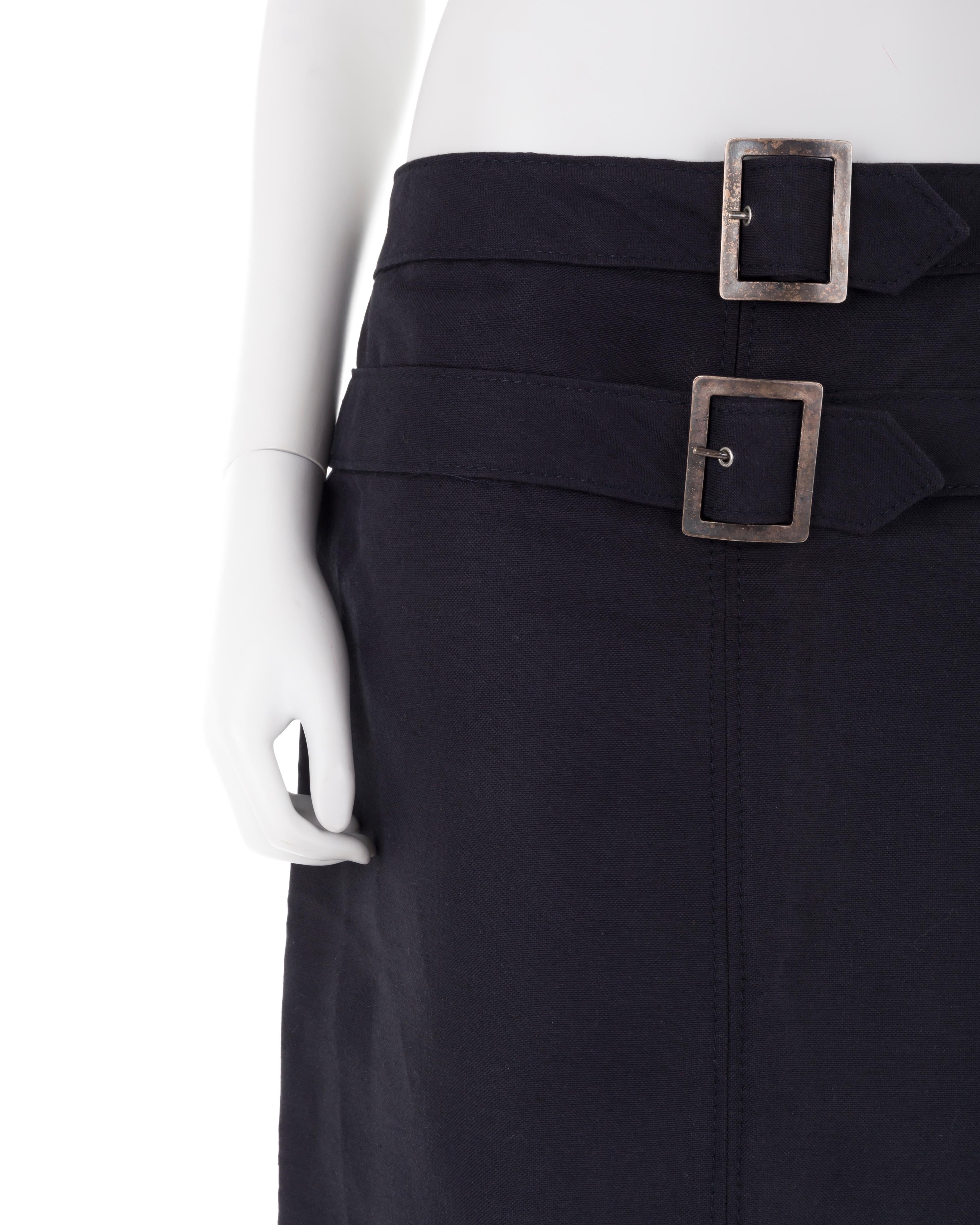 - Navy blue cotton pencil skirt
- Midi length
- Double-belted (metal has tarnished, reflected on price)
- Size UK 8