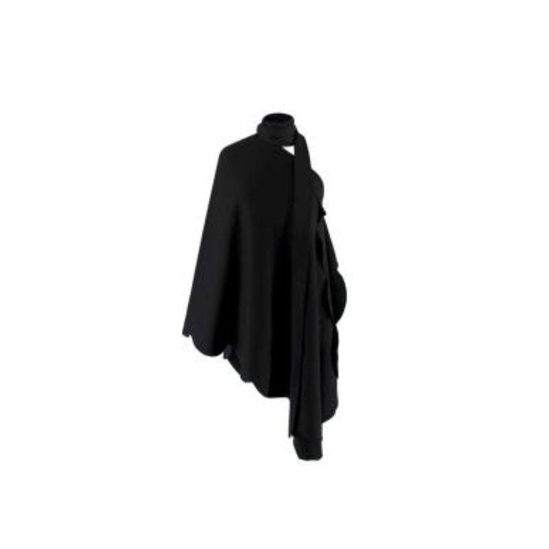 Valentino Scallop-Edged Asymmetric Cape Blouse
 

 -Pre-AW18 collection
 -black crepe cape-style blouse
 -asymmetric neckline  
 -single sleeve and long neck ties 
 -slated hem 
 -exaggerated scalloped edge
 

 Material
 -100% viscose 
 

 Washing
