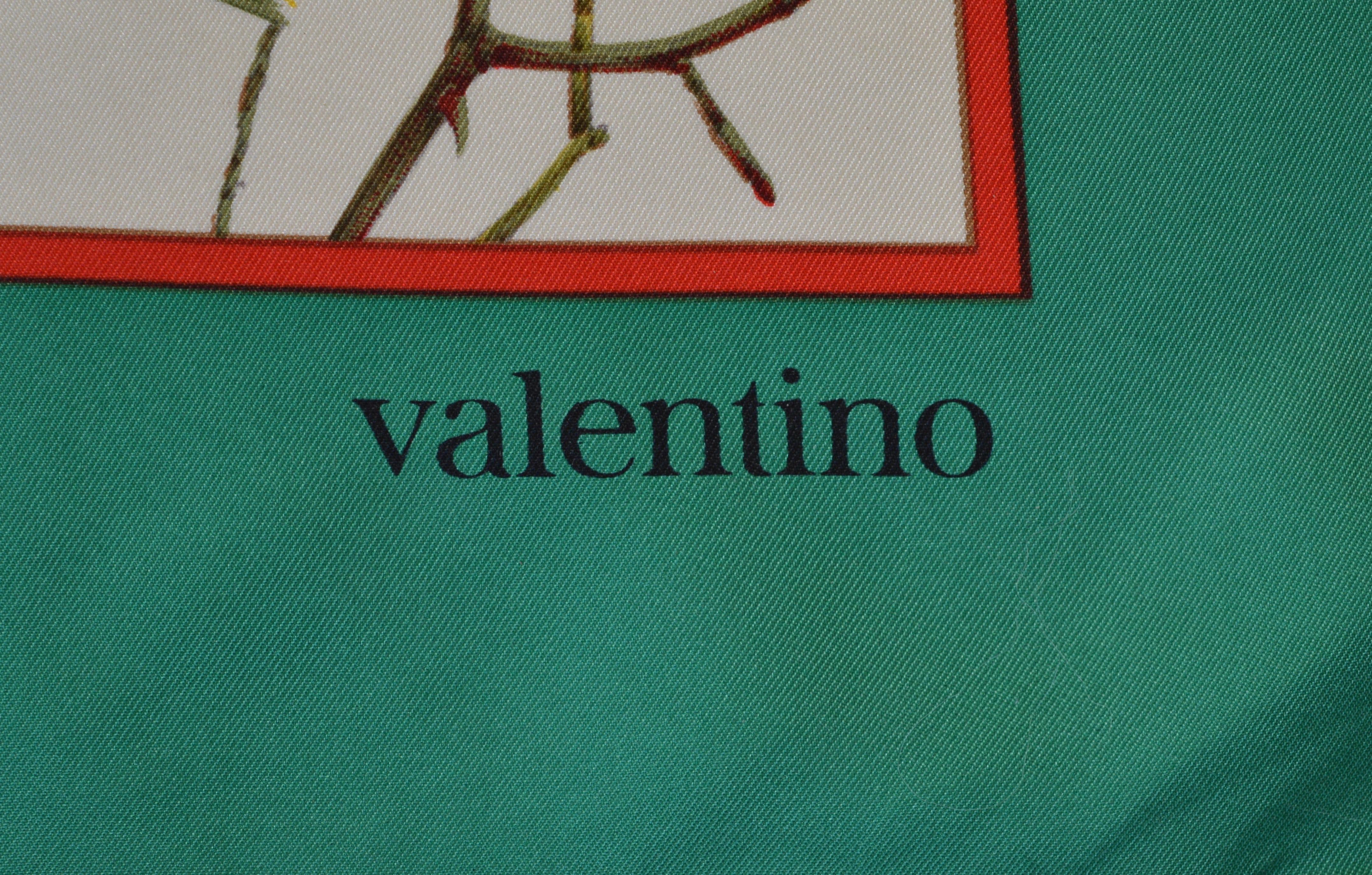 An elegant Valentino silk scarf of autumnal foilage with a grass green and brilliant red border. 
Signed Valentino in the print and handrolled edge.