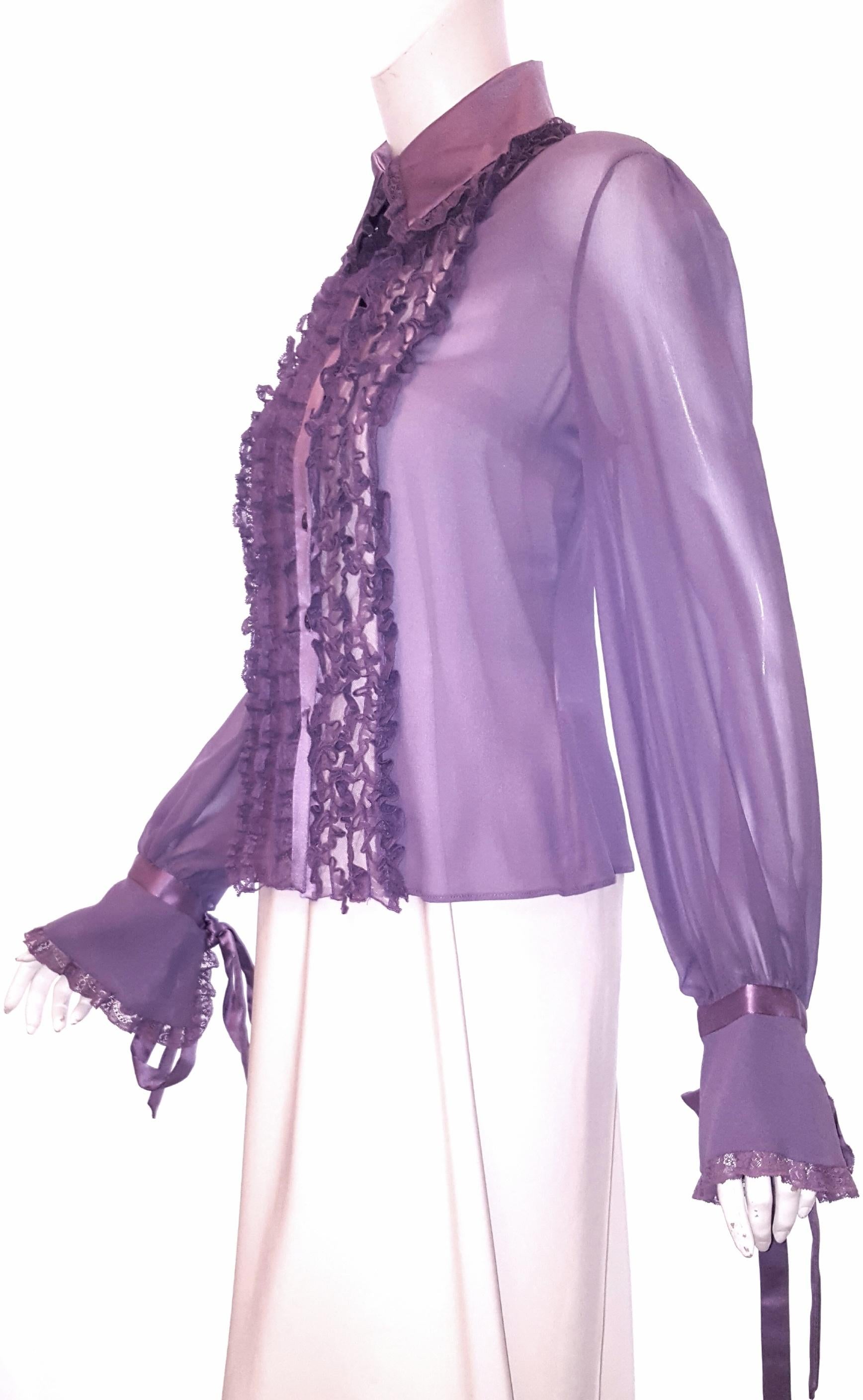 Valentino lavender long sleeve blouse combines femininity and sensuality.  This 100% silk blouse is embellished with 5 rows of lace on each side of the buttons, around the collar and on the cuffs.  The long sleeves finish with cuffs down to the