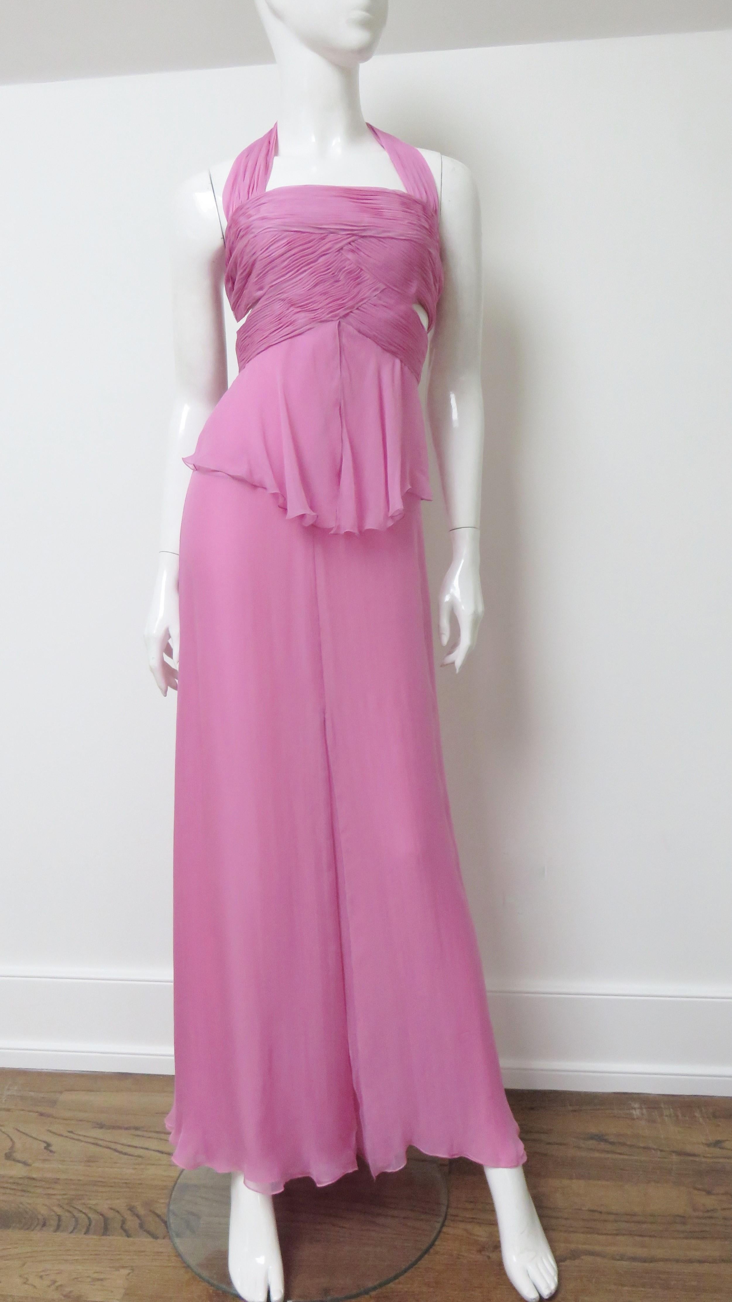 A gorgeous pink silk halter gown from Valentino S/S 2007 collection.  It has a halter neckline, fitted ruched woven panels across the  bodice with 2 cut outs on each side and 4 adjustable ties in the back- one at the neckline, one at the waist and