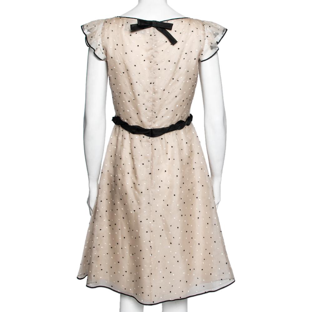 This dress by Valentino has a feminine design that will provide an alluring style statement at any party. Crafted from a blend of materials, the dress is highlighted with polka dot detailing all over and a pretty bow on the waist. This beige-colored