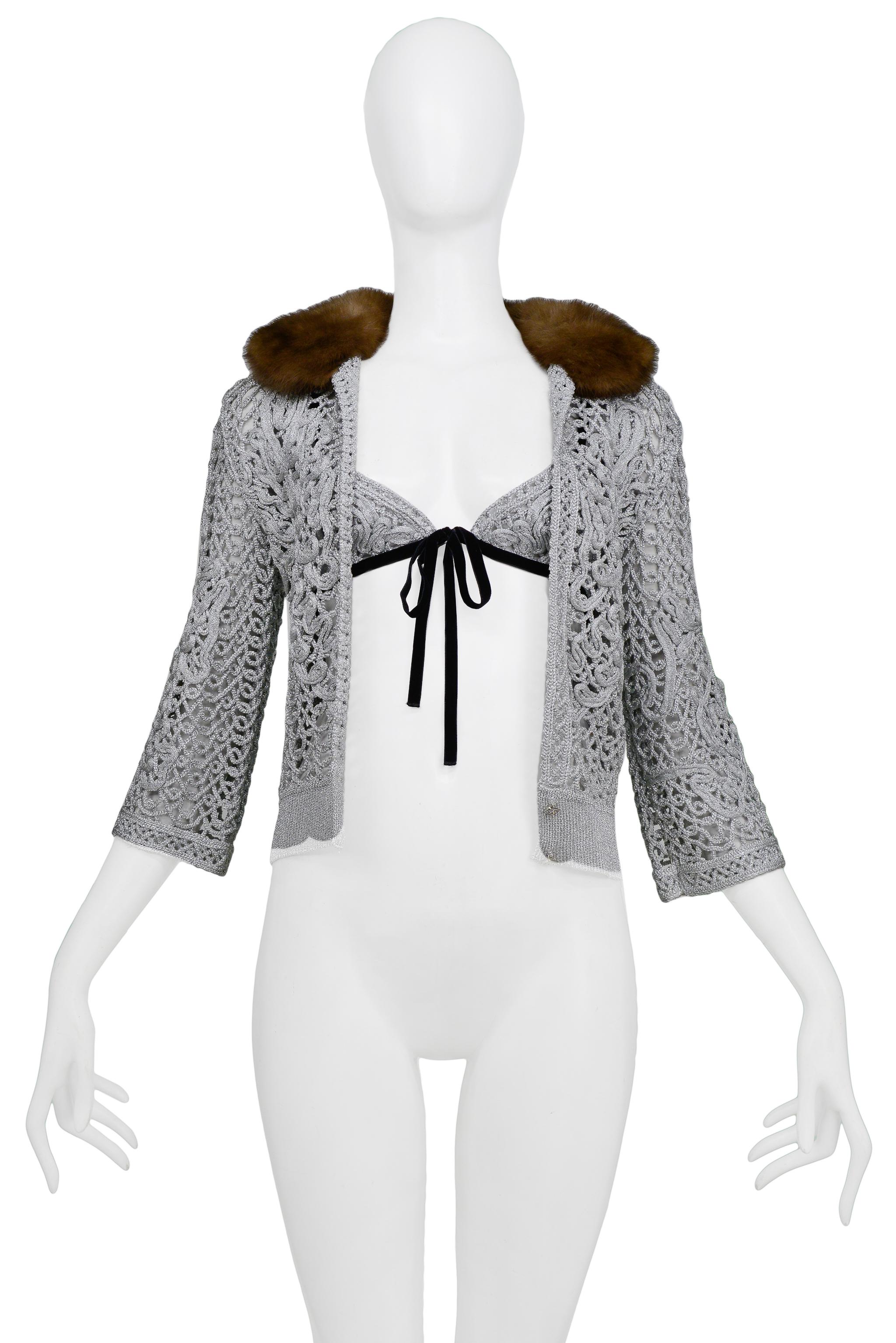 Resurrection is excited to offer a stunning Valentino metallic silver crochet cardigan sweater featuring a luxurious brown fur collar, rhinestone buttons, and a matching triangle bikini top with black velvet ties. 

Valentino
Size Medium
66% Cupro,