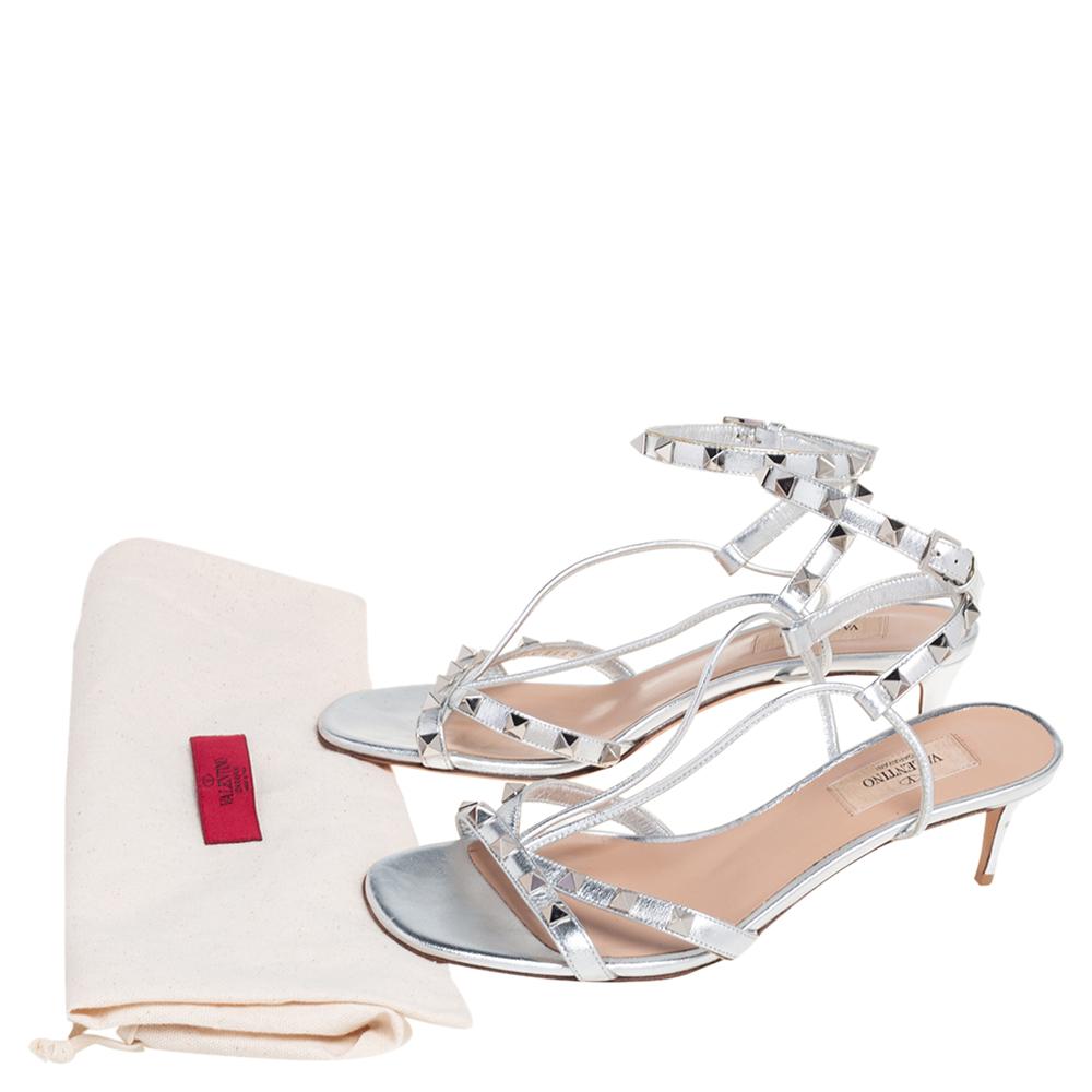 These silver sandals from Valentino are bearers of a fine mix of shoe craftsmanship and style. The leather sandals carry a strappy frame decorated with Rockstuds and are lifted on kitten heels.

Includes: Original Dustbag