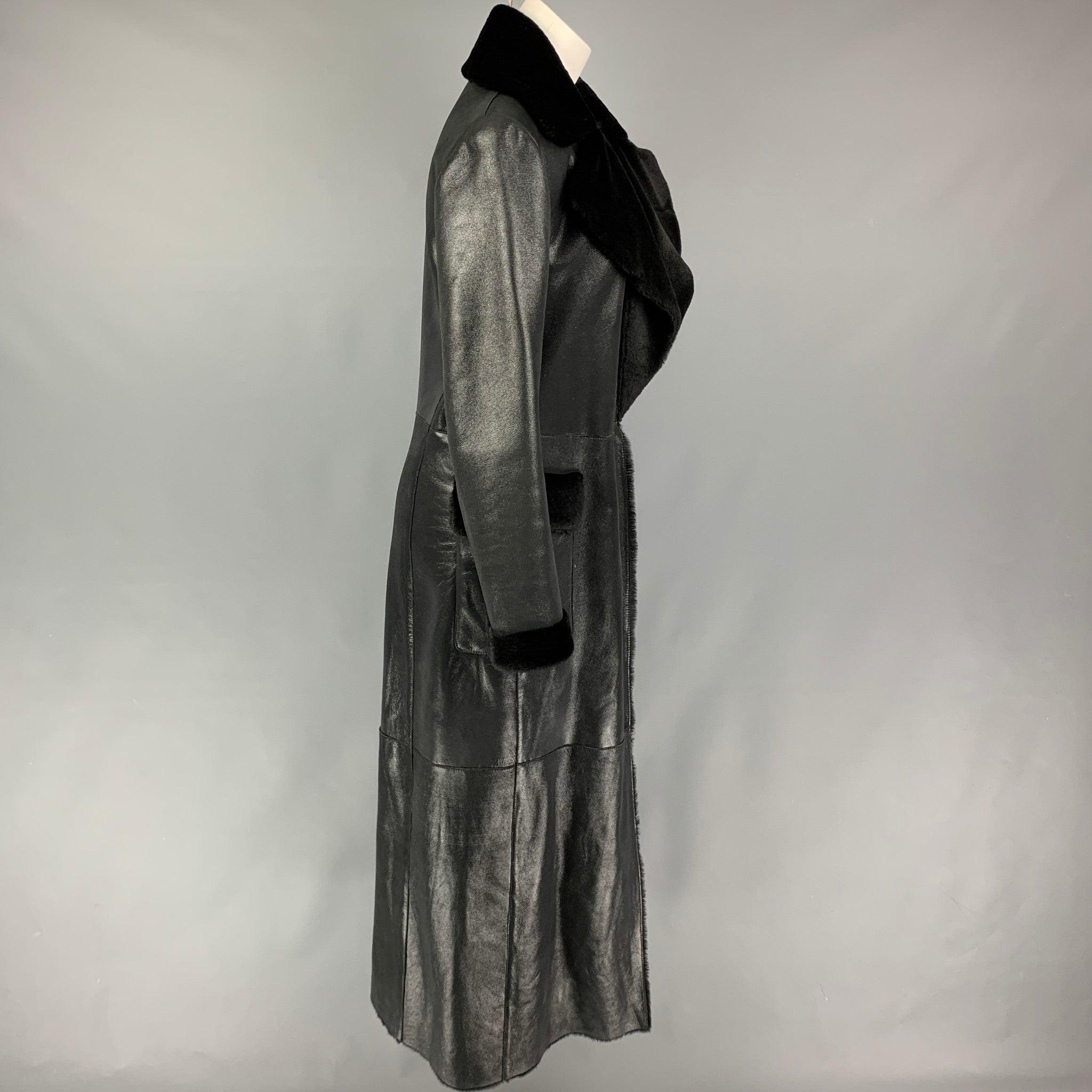 VALENTINO coat comes in a black shiny lamb shearling featuring a large lapel, flap pockets, fur trim, and a hook & eye closure. Made in Italy.
Very Good
Pre-Owned Condition. 

Marked:  10 

Measurements: 
 
Shoulder: 16.5 inches Bust: 38 inches