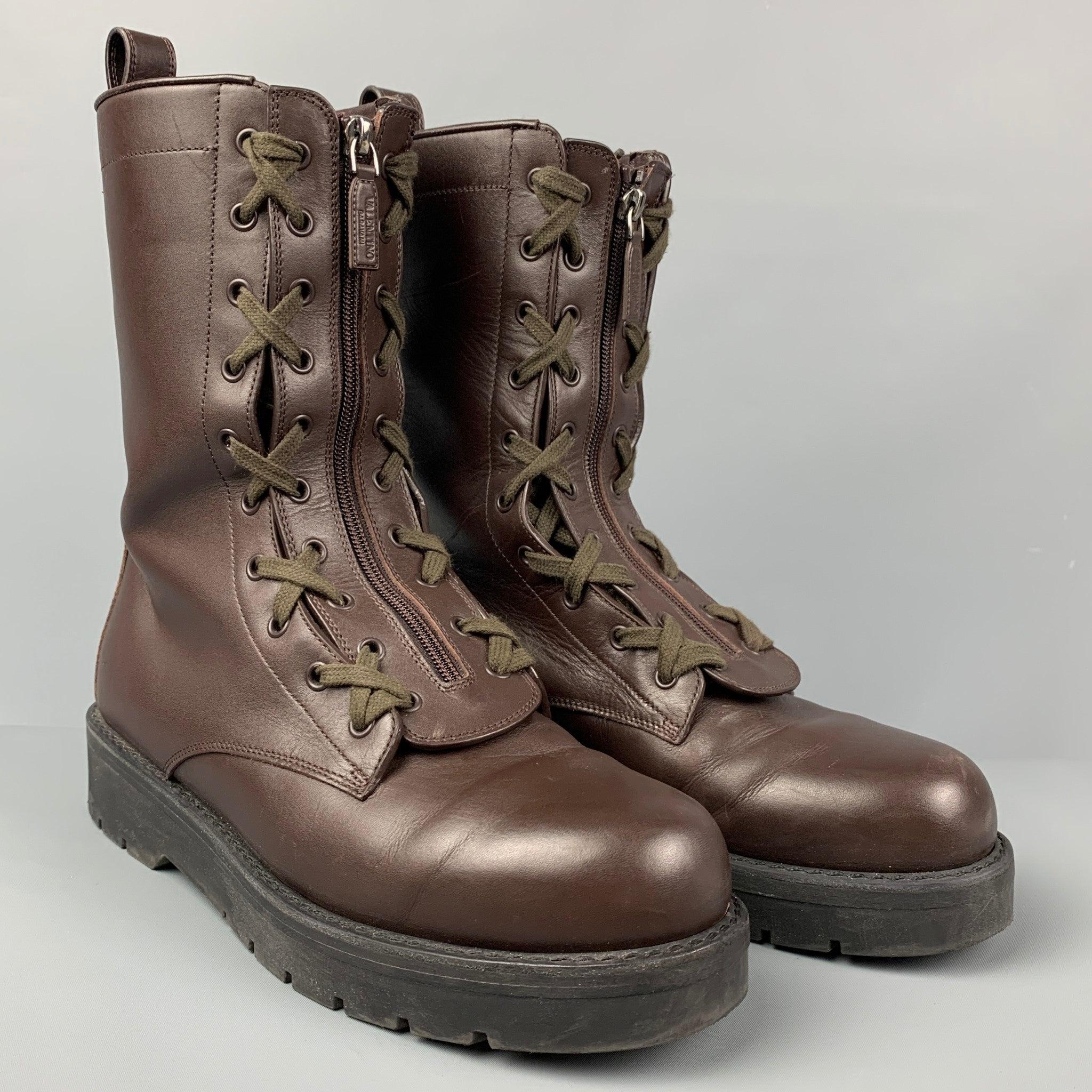 VALENTINO boots comes in a brown leather featuring a combat style, pull tan with stud embellishment, rubber sole with stud motif, and a front fastening with laces and zipper closure. Made in Italy.
Very Good
Pre-Owned Condition. 

Marked:   BUXF78 2