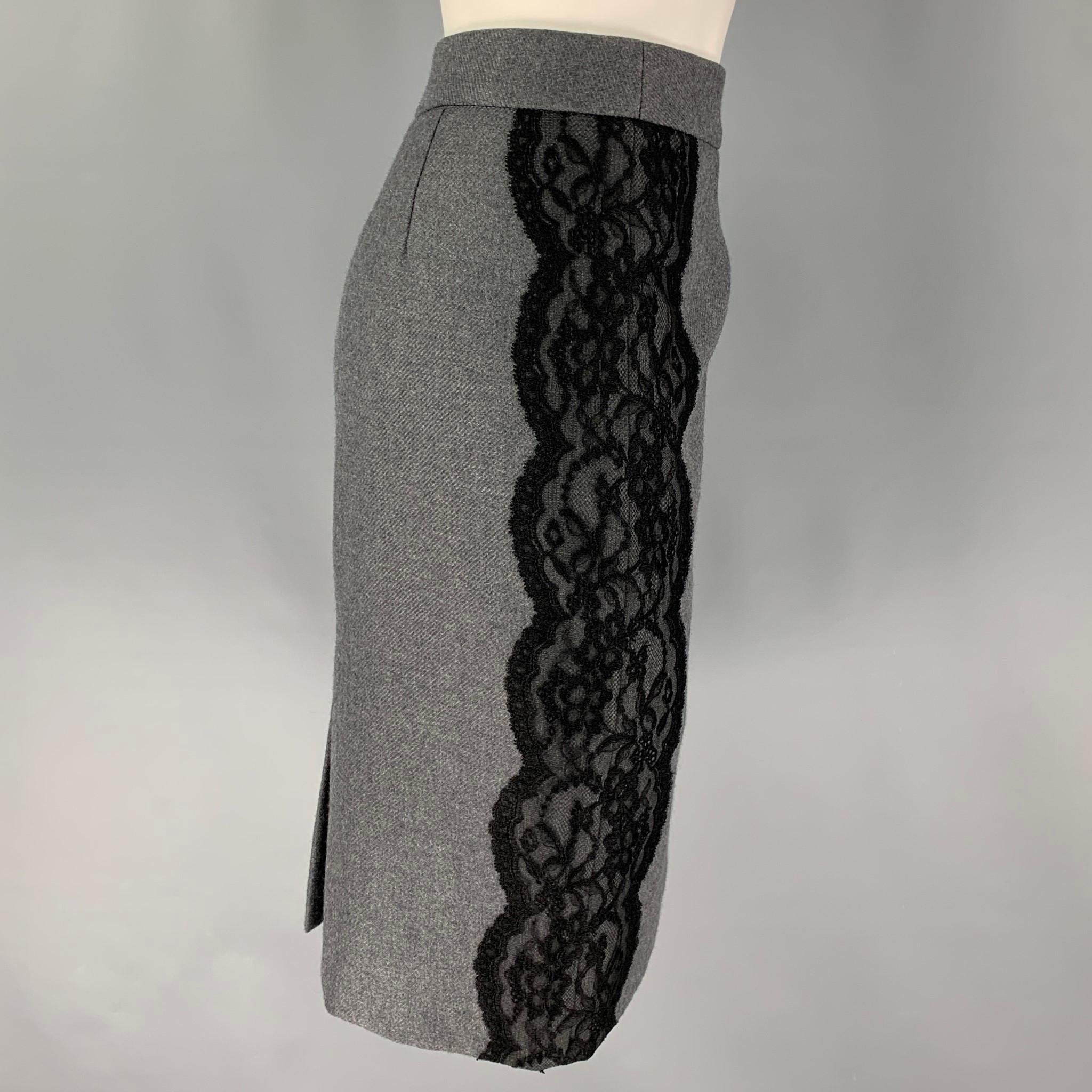 VALENTINO skirt comes in a grey wool with a slip liner featuring a pencil style, black lace panels, back slit, and a back zip up closure. Made in Italy. 

Very Good Pre-Owned Condition.
Marked: 46/10

Measurements:

Waist: 32 in.
Hip: 40 in.
Length: