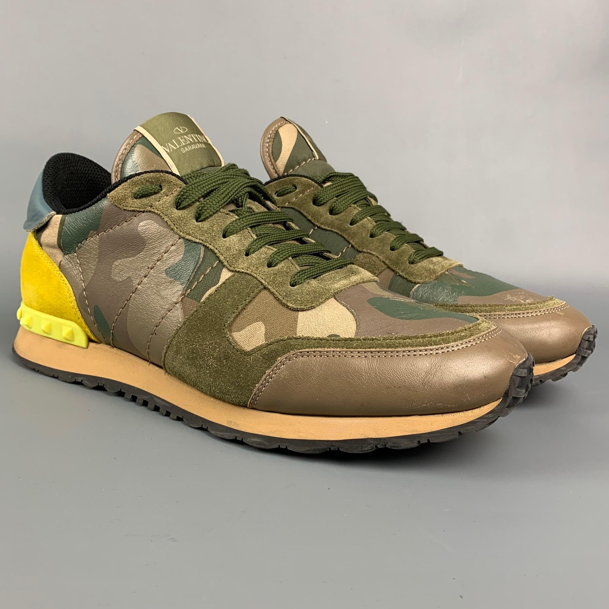 VALENTINO sneakers comes in a olive & yellow camouflage nylon with a suede trim featuring a spike detail, rubber sole, and a lace up closure. Includes box. Made in Italy.

Good Pre-Owned Condition. Minor wear throughout.
Marked: TG723 43

Outsole: