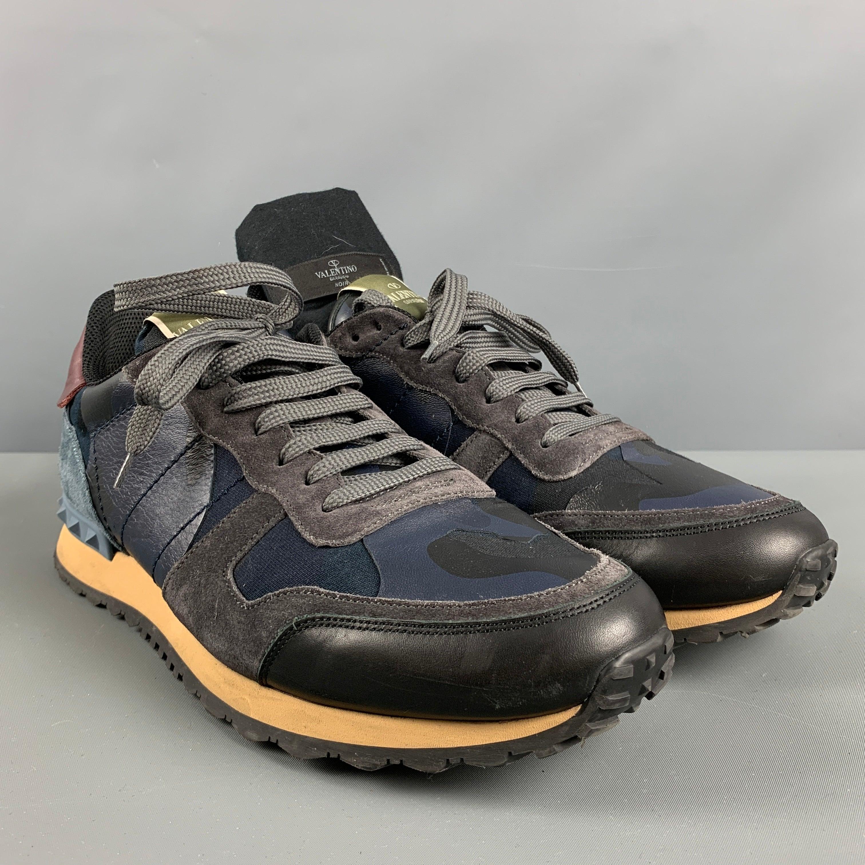 VALENTINO rock runner sneakers comes in a navy suede & leather featuring rubber stud details, color blocking design, and a lace up closure. Comes with Dust Bag. Made in Italy.Very Good Pre-Owned Condition. 

Marked:   TH723 44Outsole: 12.5 inches  x