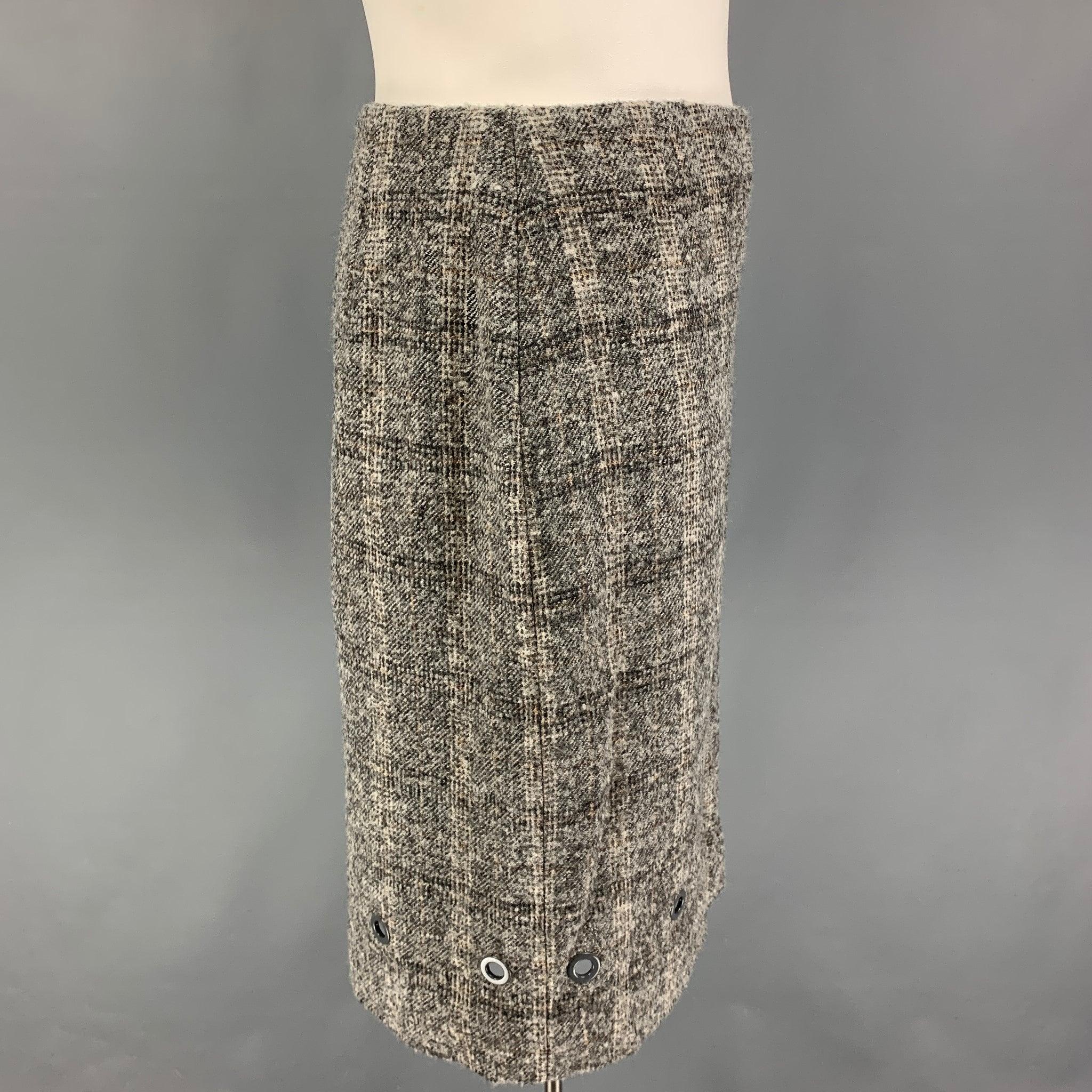 VALENTINO skirt comes in a grey & cream wool / polyamide with a slip liner featuring a pencil style, metal ring details, and a side zipper closure.
Very Good
Pre-Owned Condition. 

Marked:   48/12 

Measurements: 
  Waist: 32 inches  Hip: 44 inches 