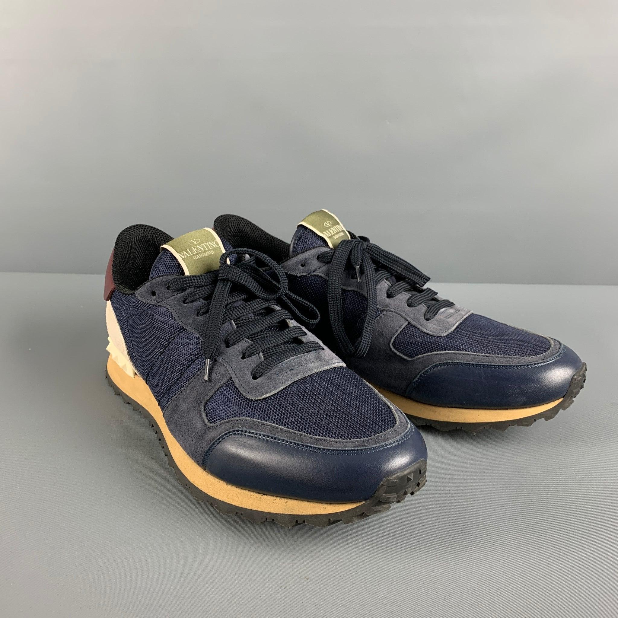 VALENTINO rock runner sneakers comes in a navy suede & leather featuring rubber stud details, color blocking design, and a lace up closure. Made in Italy. Very Good Pre-Owned Condition. 

Marked:   45Outsole: 13 inches  x 4 inches  
  
  
