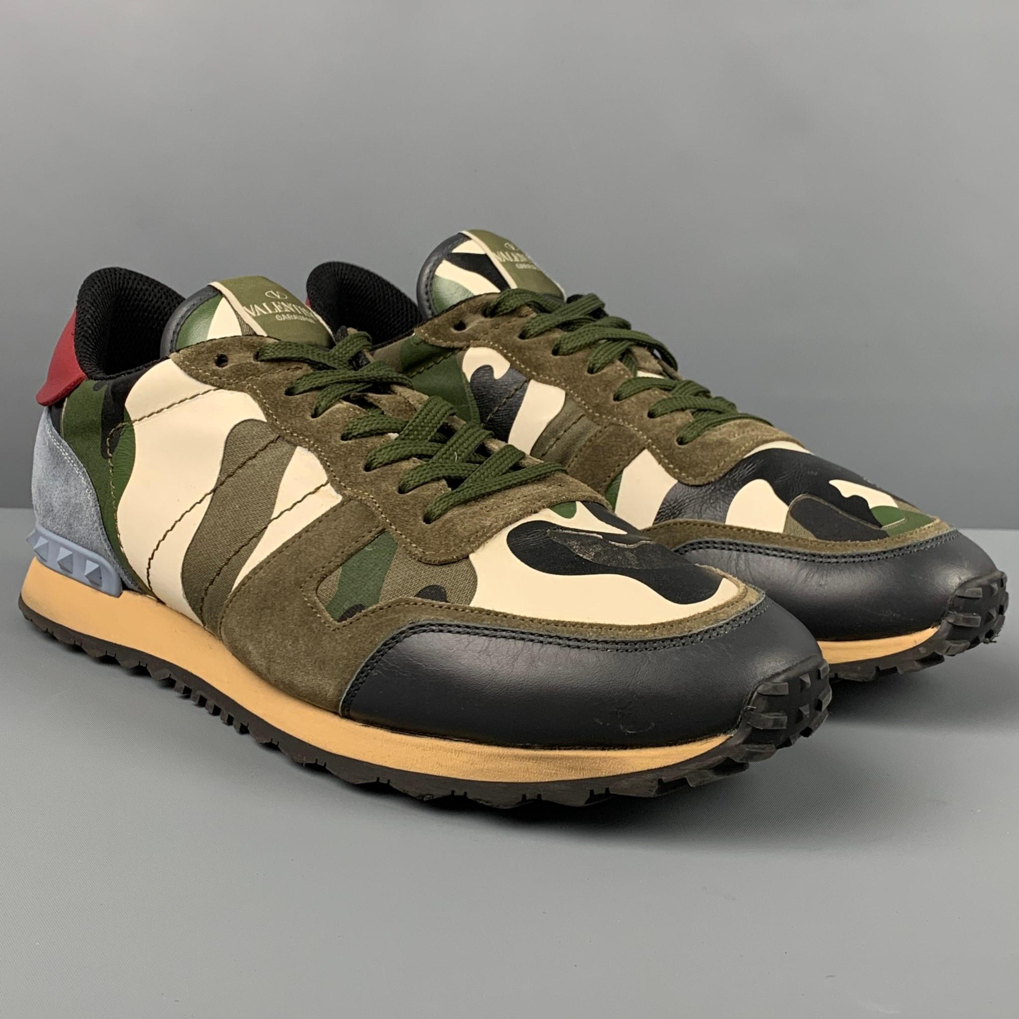 VALENTINO 'Rockrunner' sneakers comes in a olive multi-color camouflage mesh fabric with a leather trim featuring rubber stud details, rubber sole, and a lace up closure. Includes box. Made in Italy. 

Very Good Pre-Owned Condition.
Marked: TJ 723
