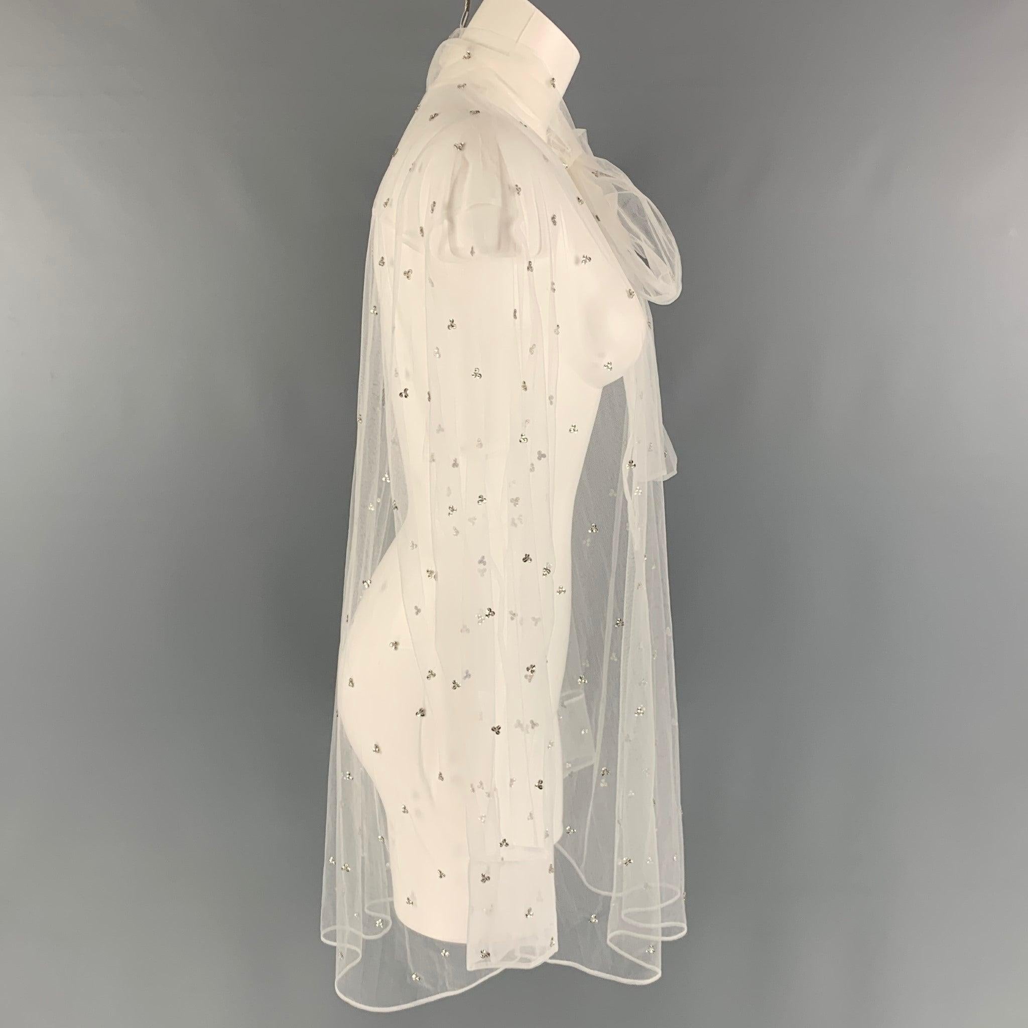VALENTINO blouse comes in a white mesh material featuring an oversized fit, embroidery crystals, see through style, neck tie and a button up closure. Made in Italy. Excellent Pre-Owned Condition.  

Marked:   48 

Measurements: 
 
Shoulder: 20