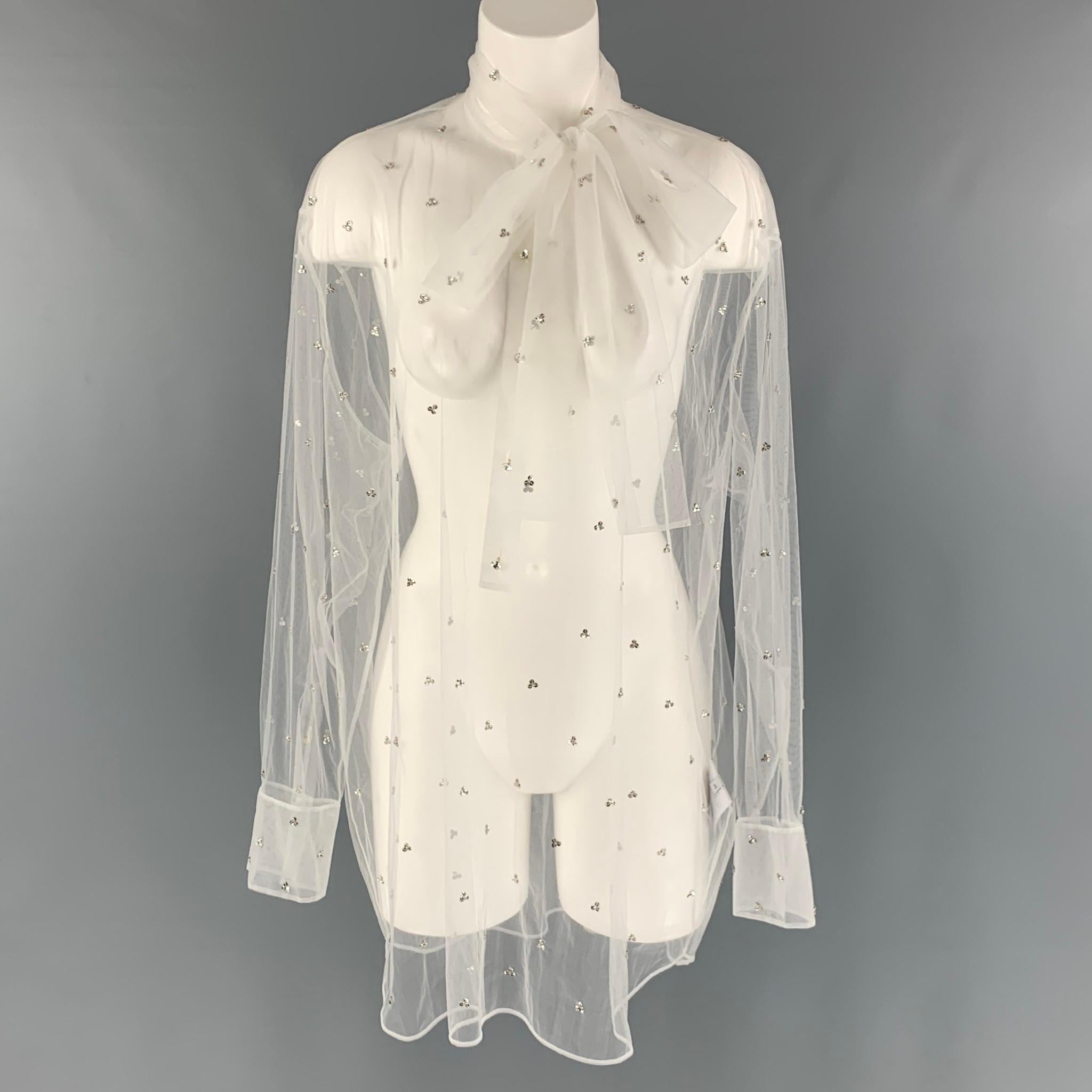 VALENTINO blouse comes in a white mesh material featuring an oversized fit, embroidery crystals, see through style, neck tie and a button up closure. Made in Italy.

Excellent Pre-Owned Condition.
Marked: 48

Measurements:

Shoulder: 20 in.
Bust: 54