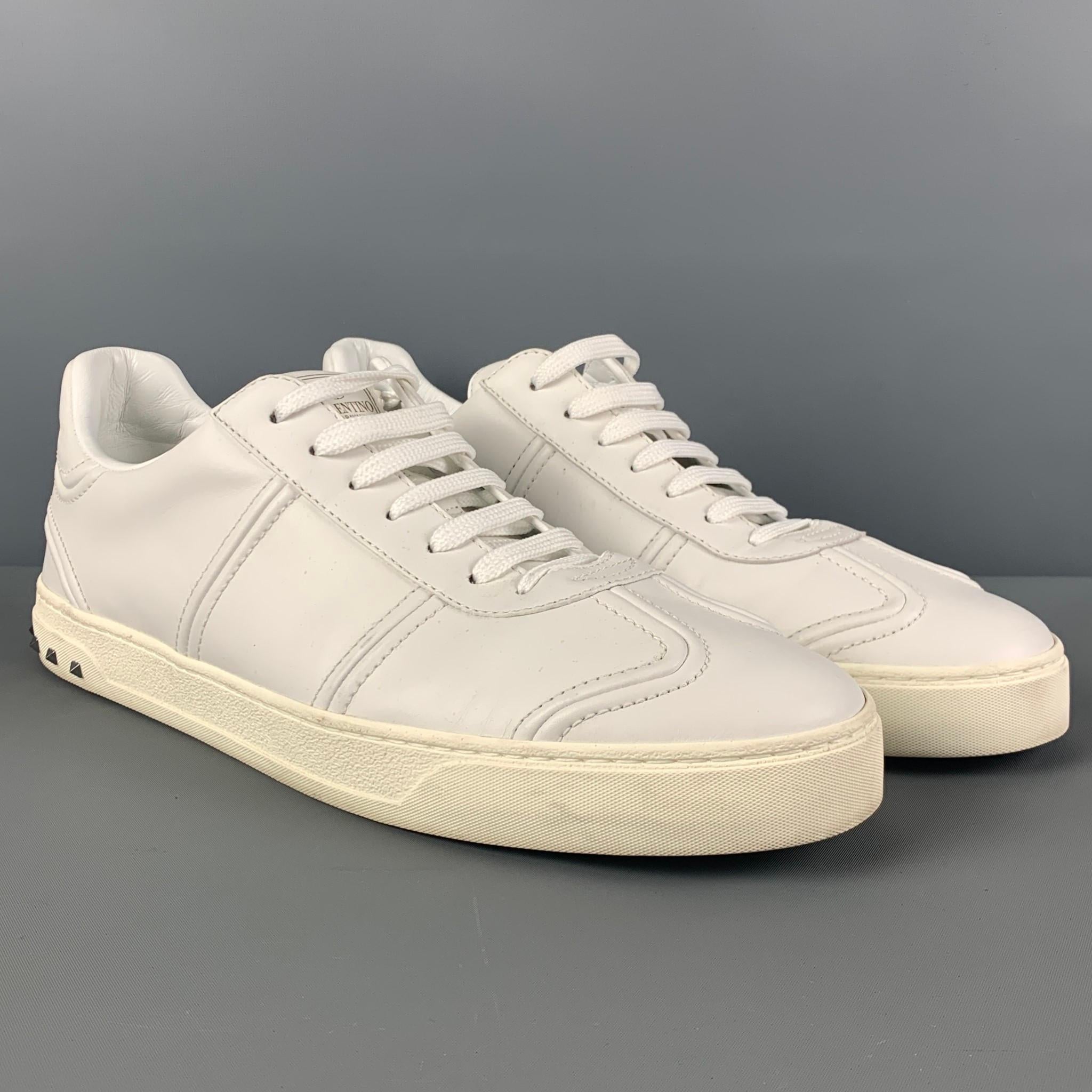 VALENTINO sneakers comes in a white leather featuring a low-top style, silver tone studs, and a lace up closure. Made in Italy. 

Very Good Pre-Owned Condition.
Marked: 45

Outsole: 12.5 in. x 4 in.