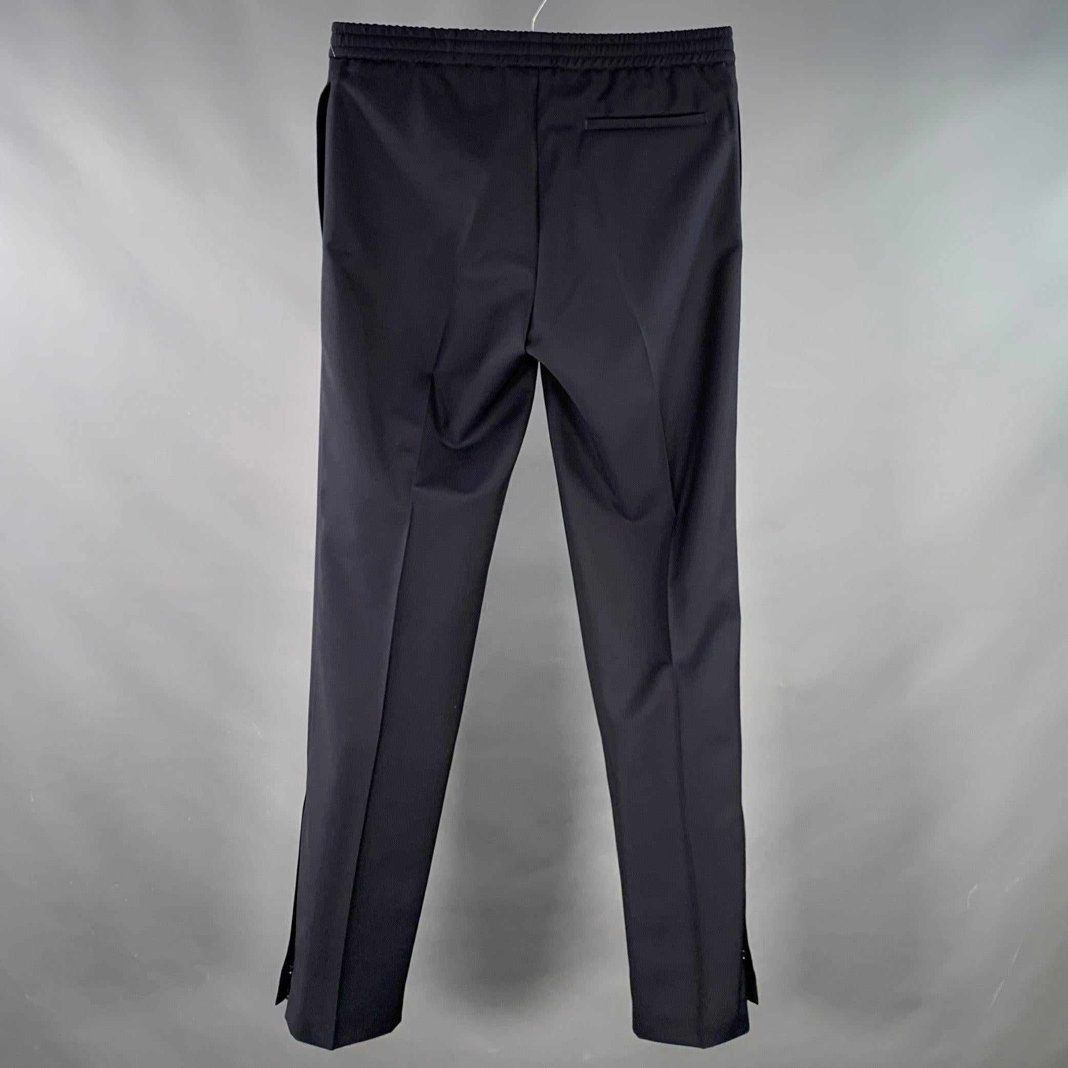 VALENTINO casual pants
in a navy wool mohair fabric featuring black double stripes down one leg, zipped cuffs, and drawstring waistband closure. Made in Italy.Excellent Pre-Owned Condition. 

Marked:   IT 46 

Measurements: 
  Waist: 30 - 36 inches