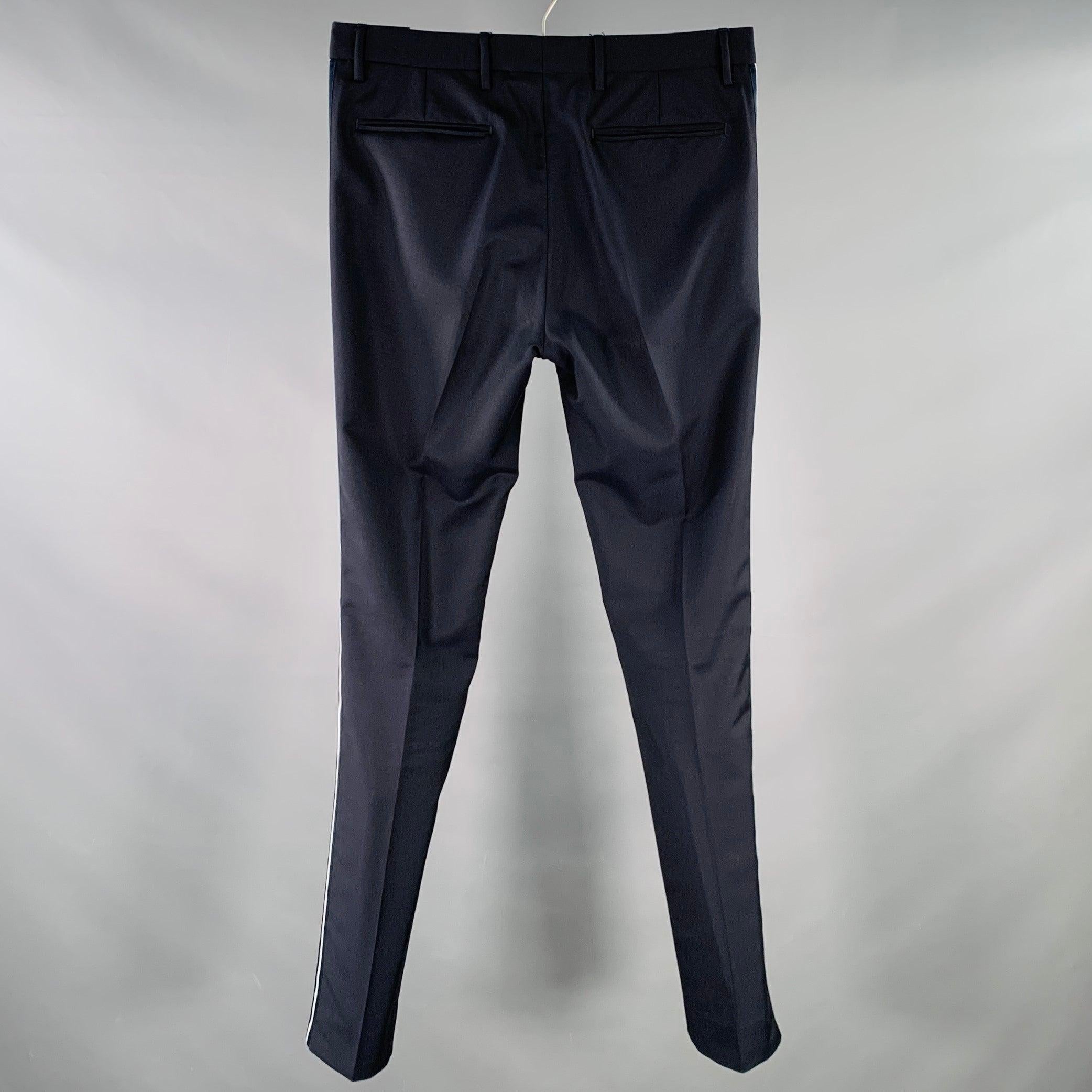 VALENTINO dress pants
in a navy wool mohair fabric featuring white tuxedo side stripes, tapered leg, and zip fly closure. Made in Italy.Excellent Pre-Owned Condition.  

Marked:   IT 46 

Measurements: 
  Waist: 30 inches Rise: 9 inches Inseam: 33