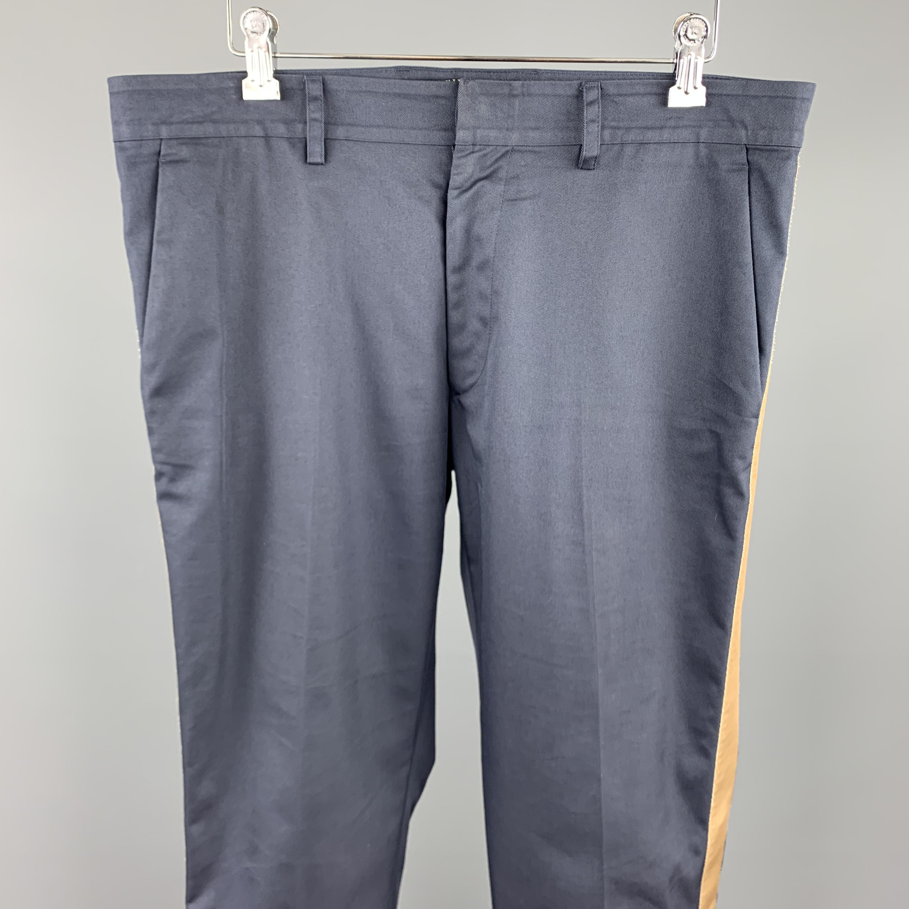 VALENTINO casual pants comes in a navy cotton / polyamide featuring a slim fit, folded cuffs, and a zip fly closure. Made in Italy.

Very Good Pre-Owned Condition.
Marked: IT 48

Measurements:

Waist: 34 in. 
Rise: 9 in. 
Inseam: 29 in. 

 