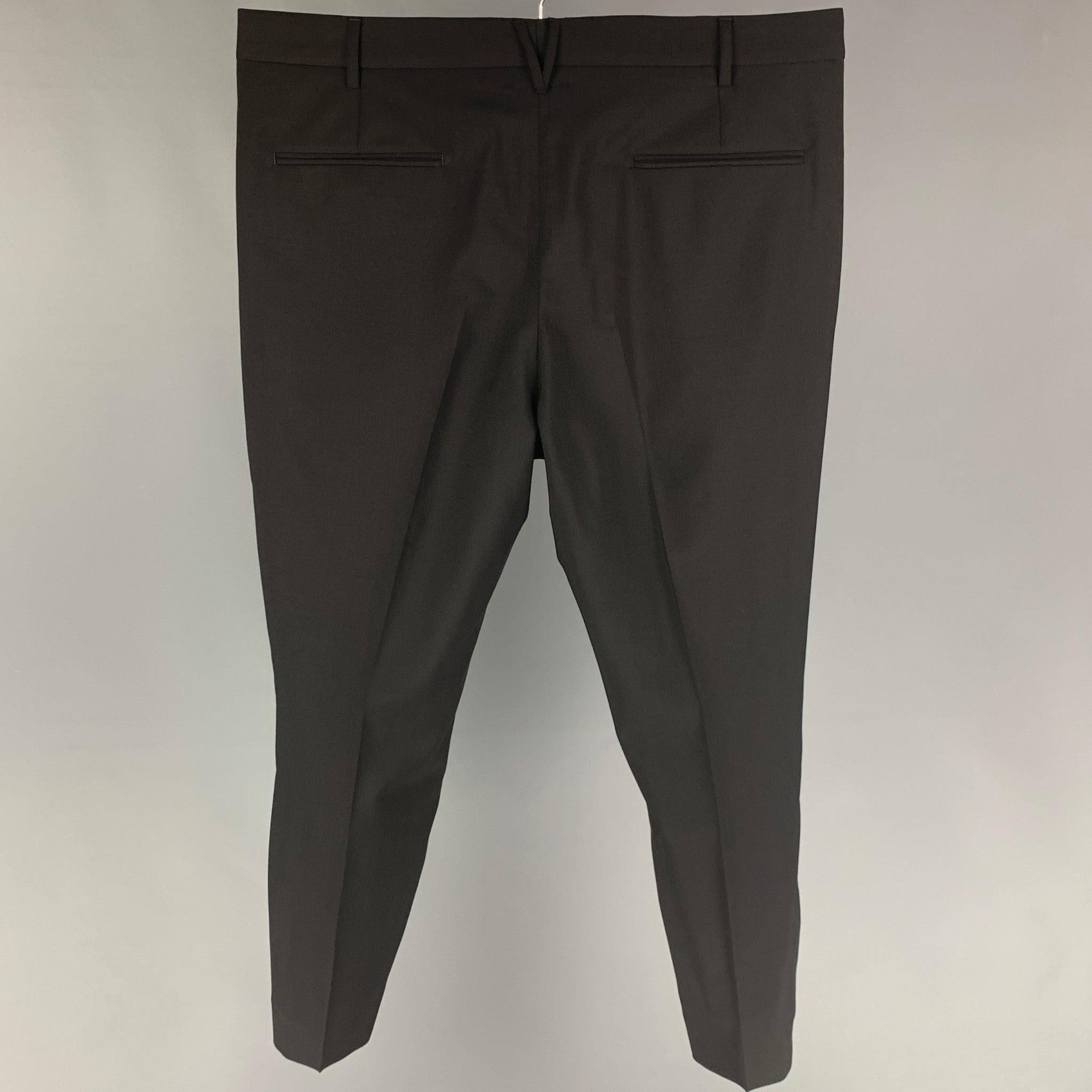 VALENTINO dress pants comes in a black wool / mohair featuring a flat front, front tab, and a zip fly closure. Made in Italy.
Very Good
Pre-Owned Condition. 

Marked:   50 

Measurements: 
  Waist: 36 inches  Rise: 11 inches  Inseam: 26 inches 
  
 