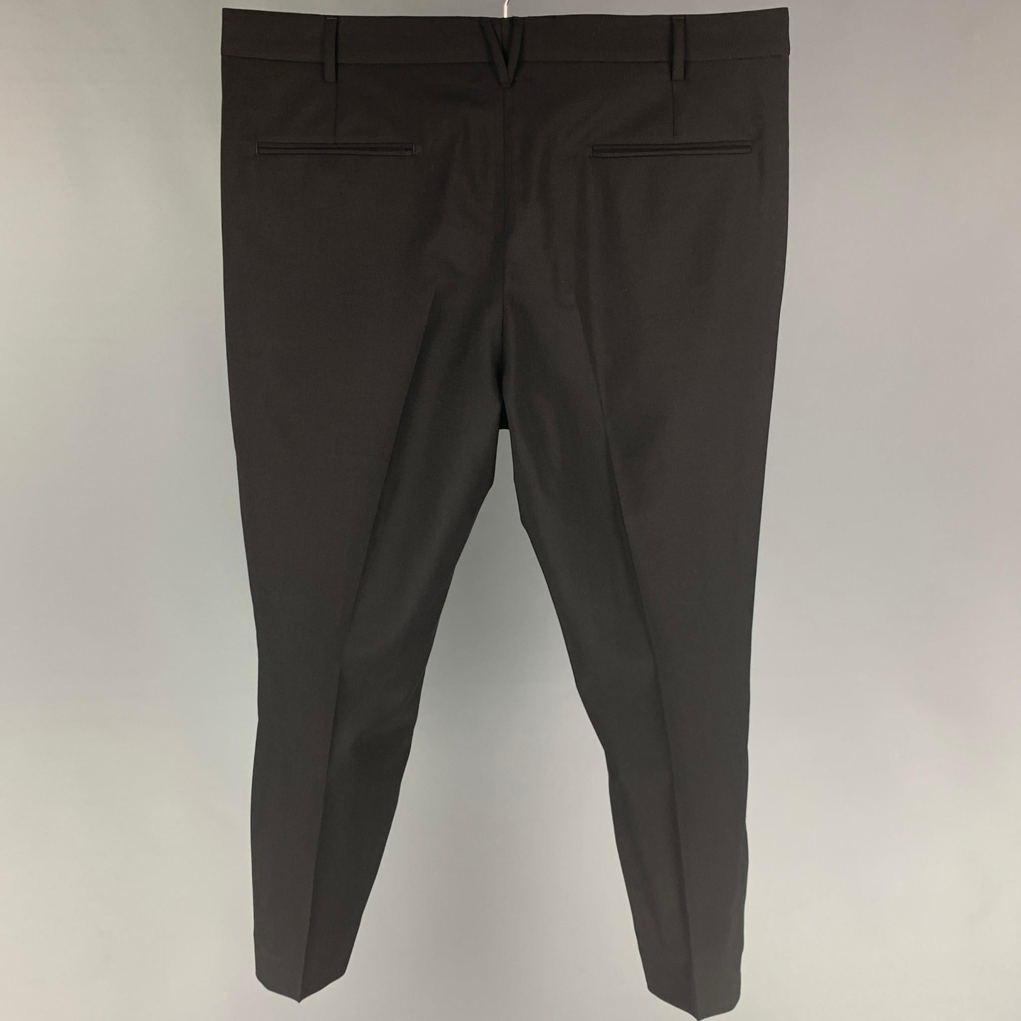 VALENTINO dress pants comes in a black wool / mohair featuring a flat front, front tab, and a zip fly closure. Made in Italy. 

Very Good Pre-Owned Condition.
Marked: 50

Measurements:

Waist: 36 in.
Rise: 11 in.
Inseam: 26 in.