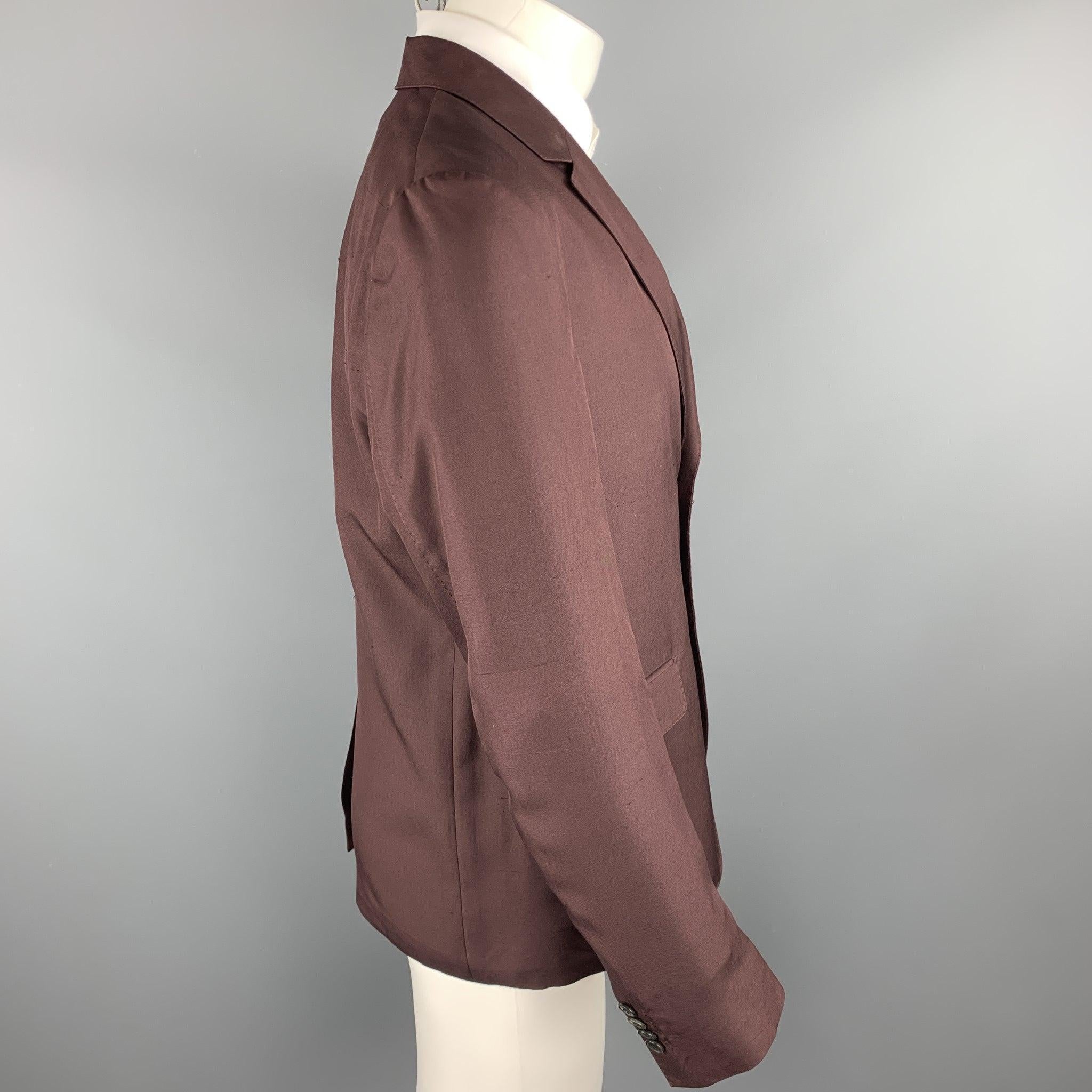 VALENTINO sport coat comes in a burgundy silk featuring a notch lapel, flap pockets, and a two button closure. Made in Italy.Excellent
Pre-Owned Condition. 

Marked:   IT 48 

Measurements: 
 
Shoulder: 17 inches Chest: 40 inches 
Sleeve: 26.5