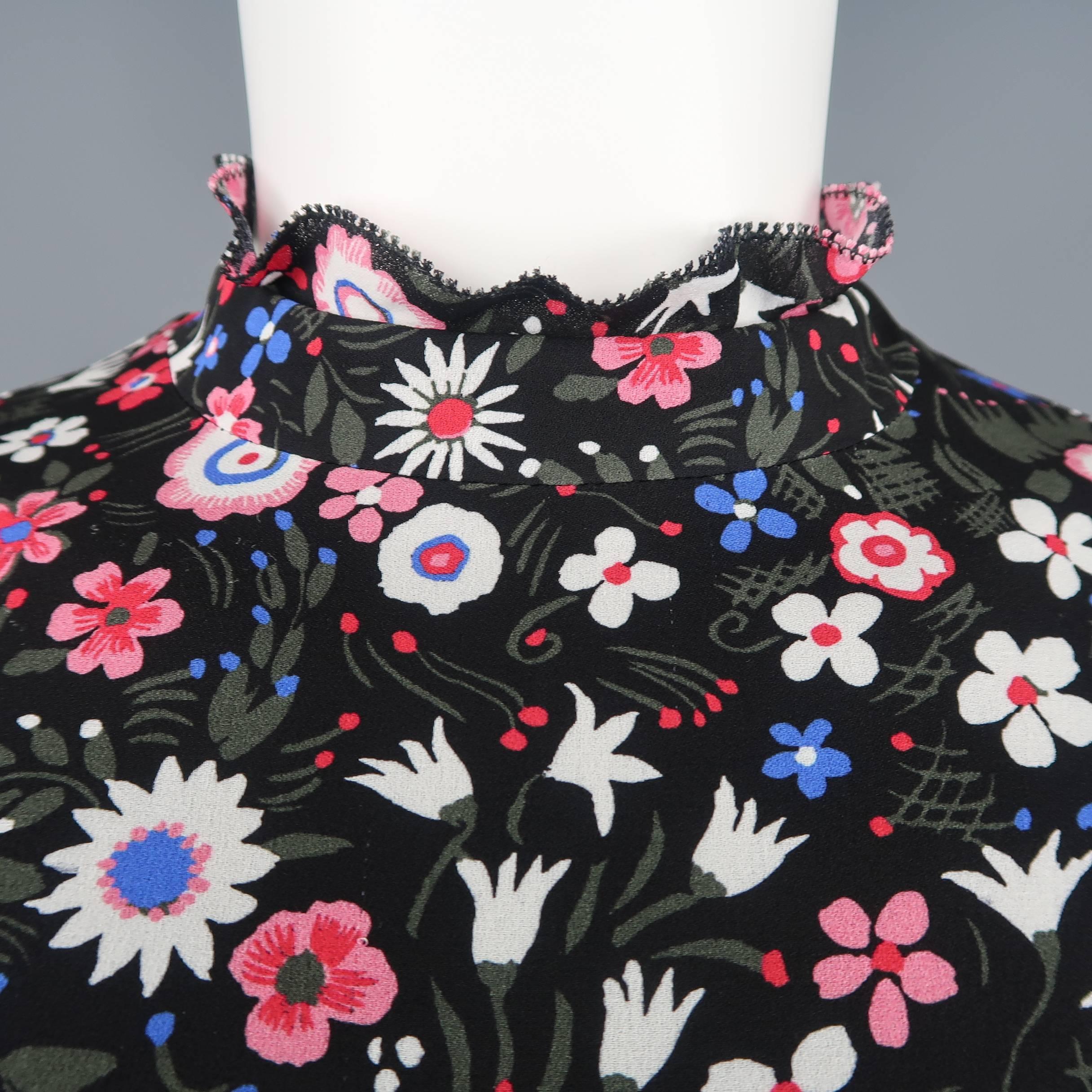 VALENTINO tunic dress comes in black silk with all over pink, blue, and white floral print and features a ruffled band collar, a line silhouette, and button cuffed shirt sleeves. Made in Italy.
 
Excellent Pre-Owned Condition.
Marked: 4
