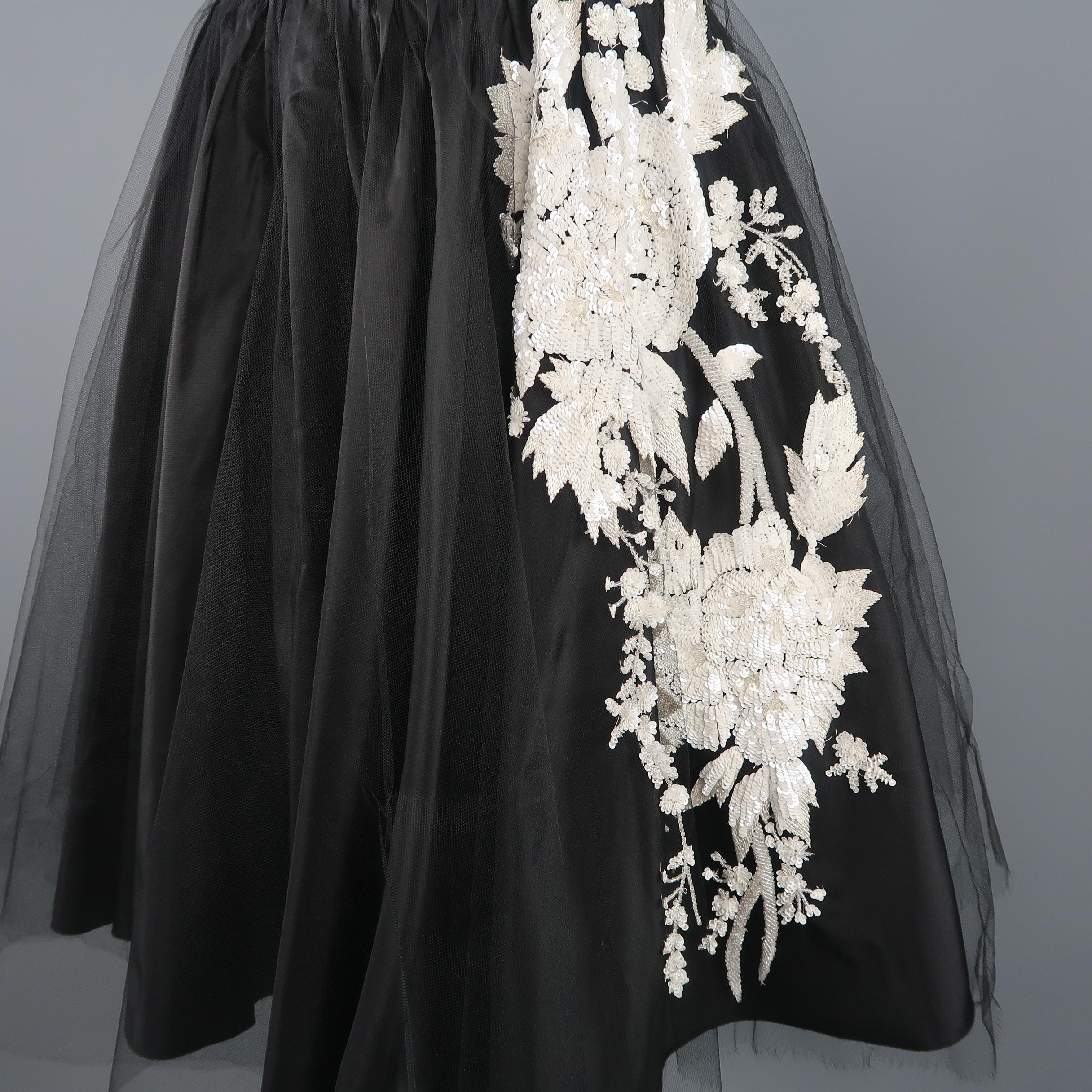 VALENTINO A line skirt comes in black taffeta with a tulle overlay detailed with white sequin floral applique. Made in Italy.
 
Excellent Pre-Owned Condition.
Marked: 4
 
Measurements:
 
Waist: 30 in.
Hip: 60 in.
Length: 22 in.