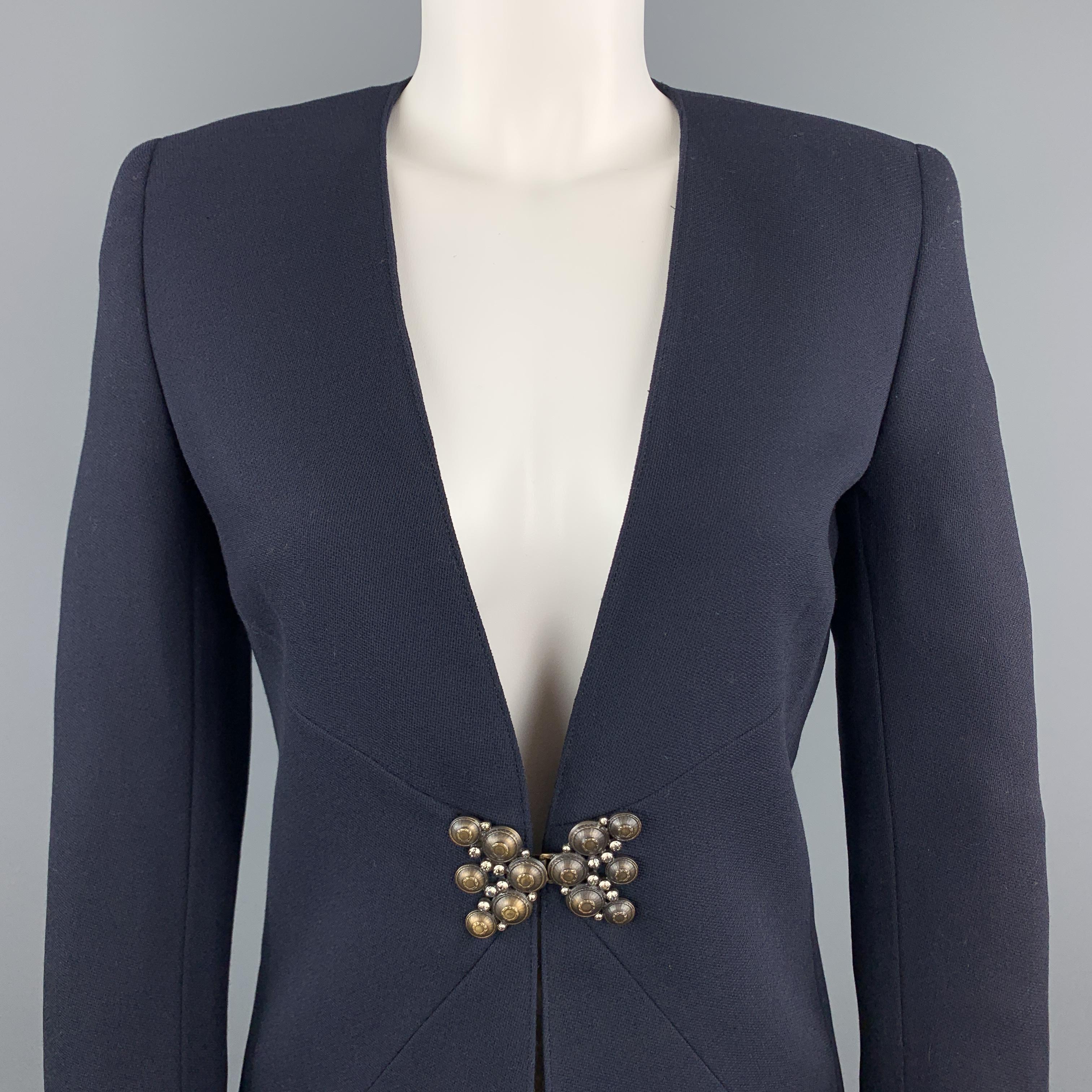 Vintage MISS V VALENTINO jacket comes in navy blue woven wool with a collarless V neck line, tailored silhouette, and antique gold tone hinge brooch closure with clear rhinestones. Made in Italy.

Excellent Pre-Owned Condition.
Marked: USA