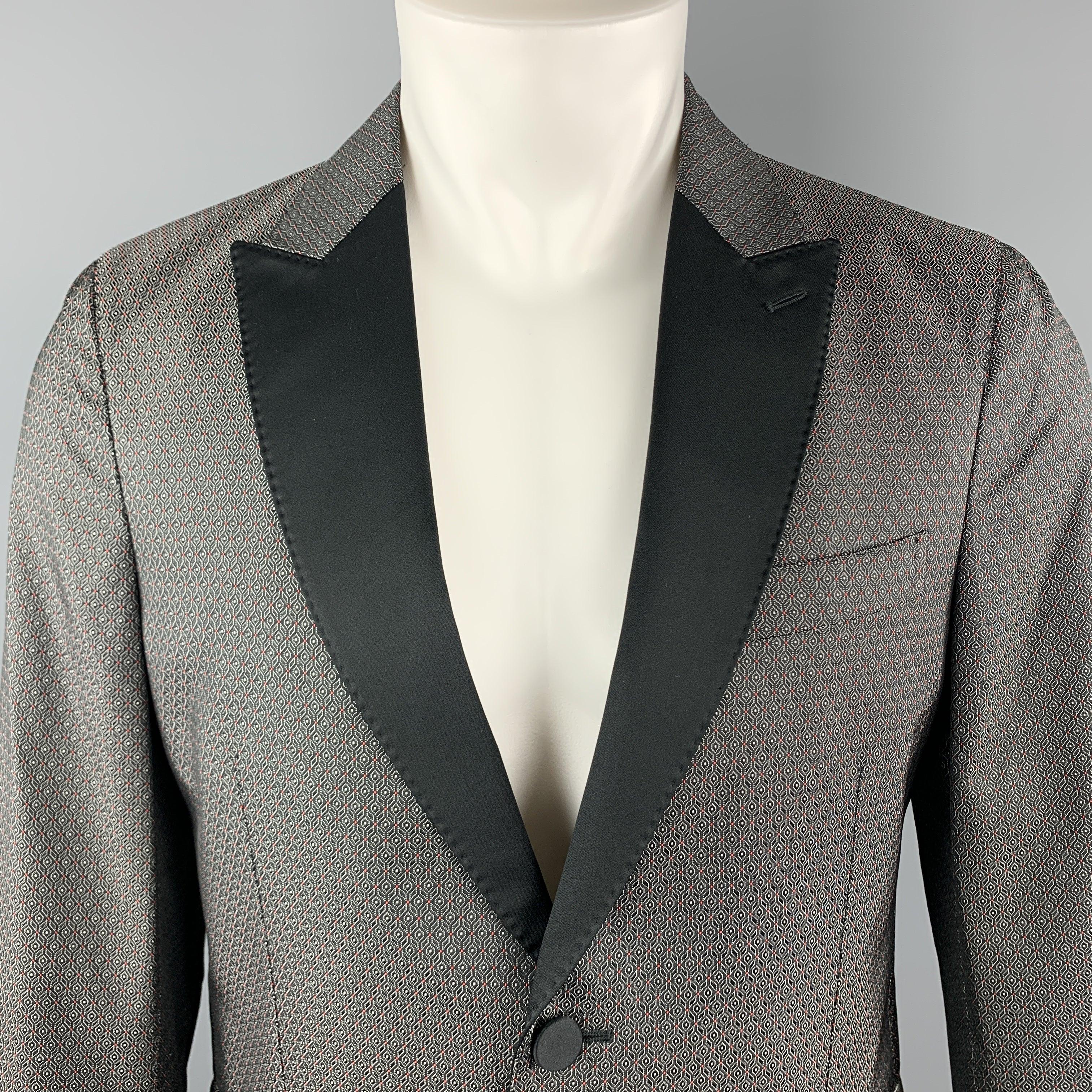 VALENTINO Tuxedo Sport Coat
comes in gray and black jacquard polyester / silk material, with a peak lapel, slit and flap pockets, single breasted, two buttons at closure, buttoned cuffs, and a single vent at back. Made in Italy.
Excellent Pre-Owned