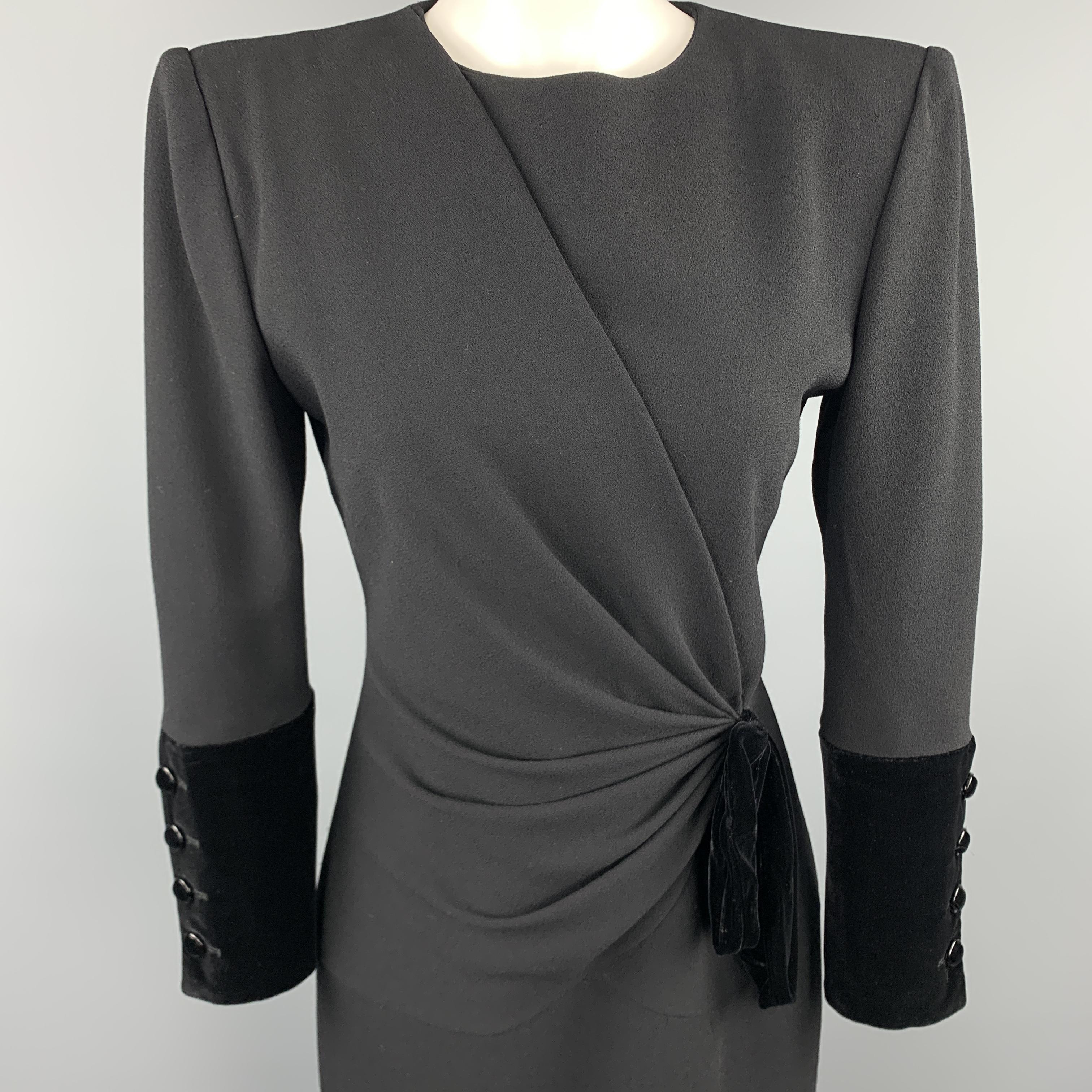 Vintage VALENTINO cocktail dress comes in black crepe with a structured shoulder, high collarless neckline, velvet button cuffs, and asymmetrical draped front with velvet bow accent. Made in Italy.

Excellent Pre-Owned Condition.
Marked: US