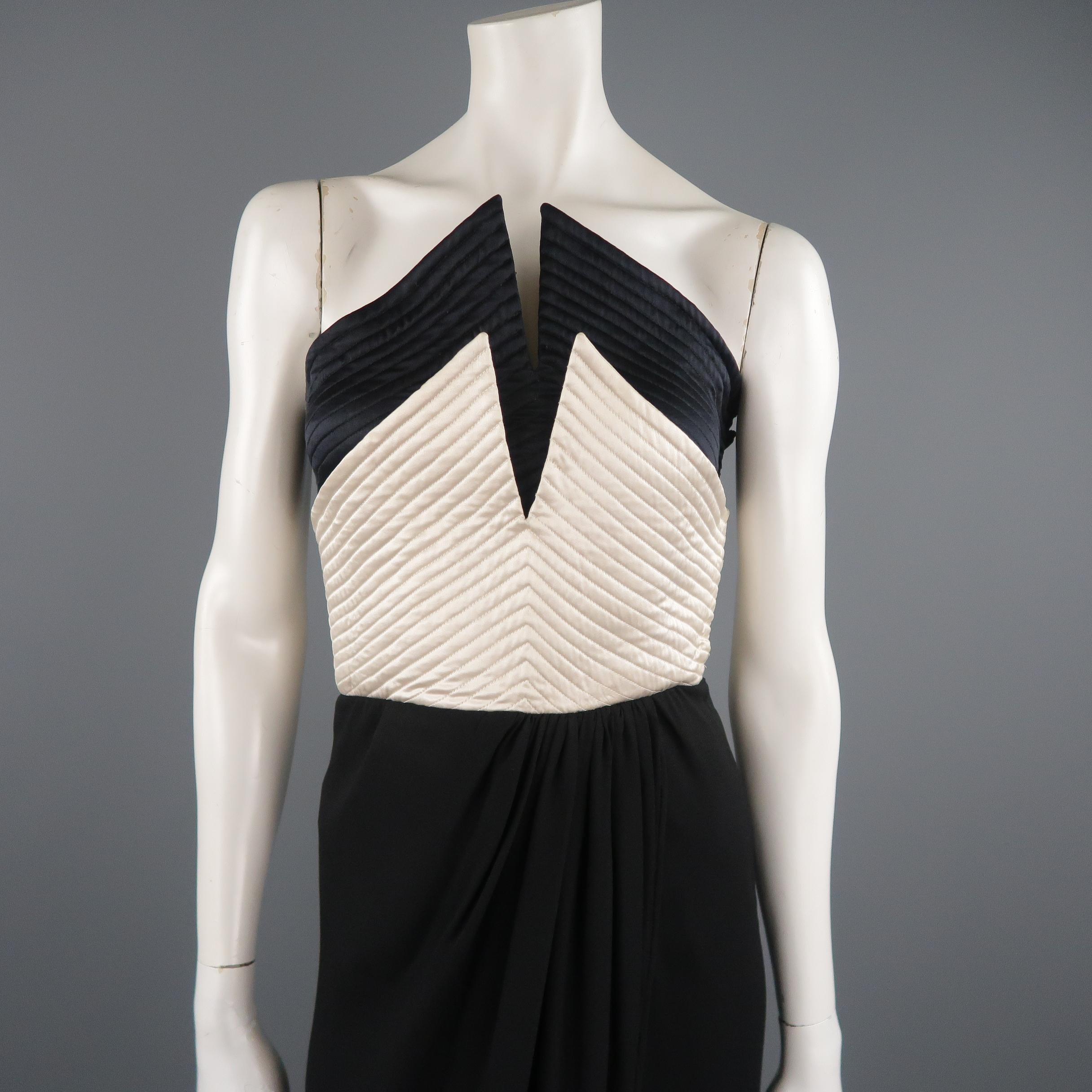 This fabulous vintage 1980's VALENTINO cocktail dress features a layered satin quilted point bustier top with crepe wrap skirt. Made in Italy.
 
Very Good Pre-Owned Condition.
Marked: 6
 
Measurements:
 
Bust: 32 in.
Waist: 26 in.
Hip: 38