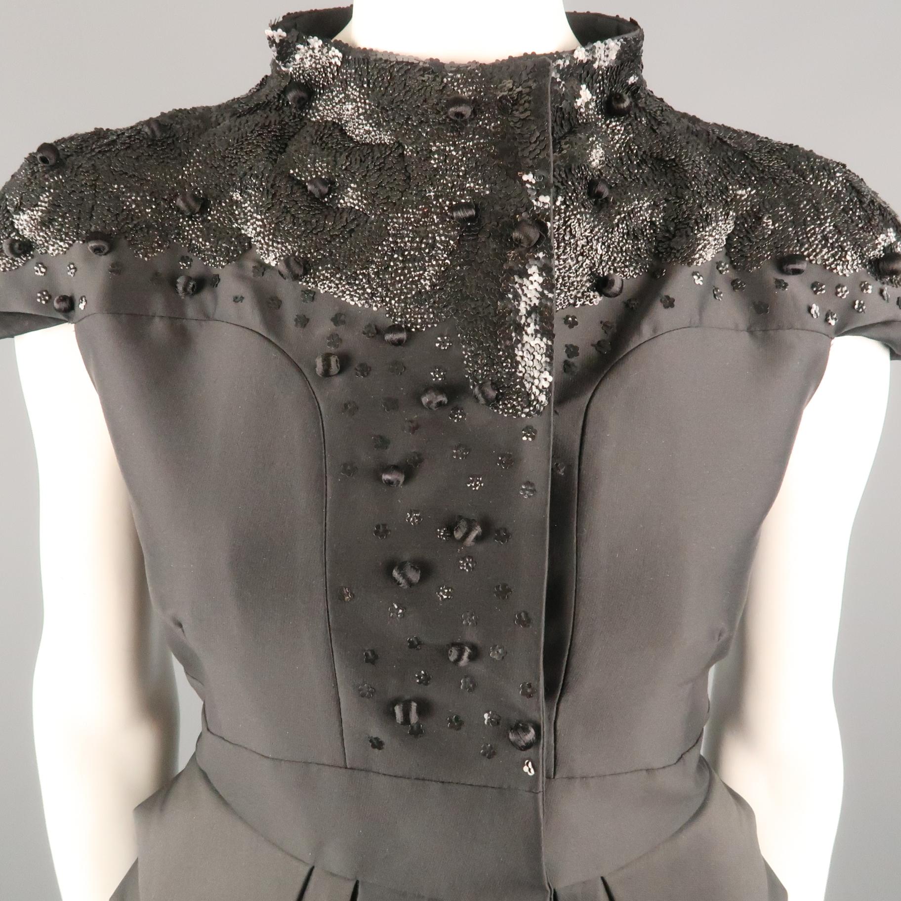 VALENTINO evening jacket comes in black wool with a high neck, double breasted snap closure front, layered peplum, cup sleeves, and sequin and bead embellishments. Silk lined. Made in Italy.
 
Very Good Pre-Owned Condition.
Marked: 6
